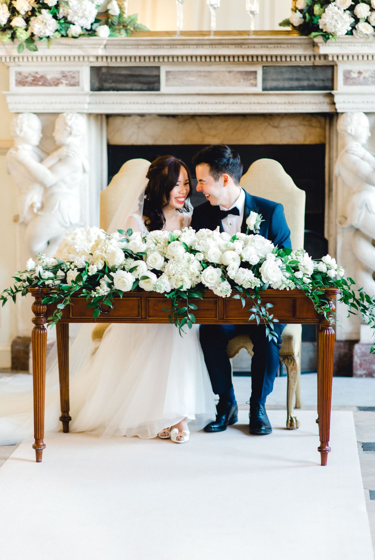 Couple signing the registry Gosfield Hall Essex