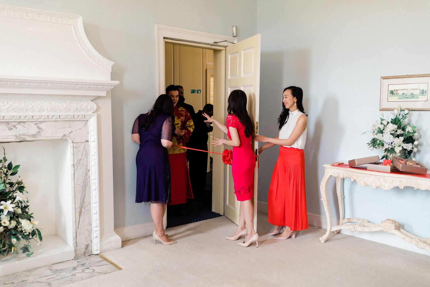 Groom and groomsmen entering tea ceremony Gosfield Hall Essex - candid wedding photography