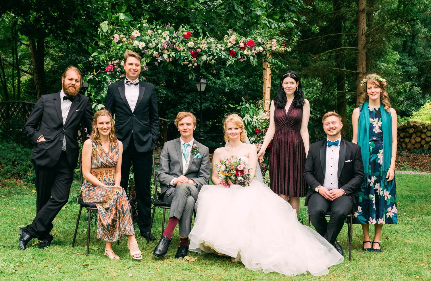 Formal wedding party group photo with bride and groom in the centre in wedding venue in France