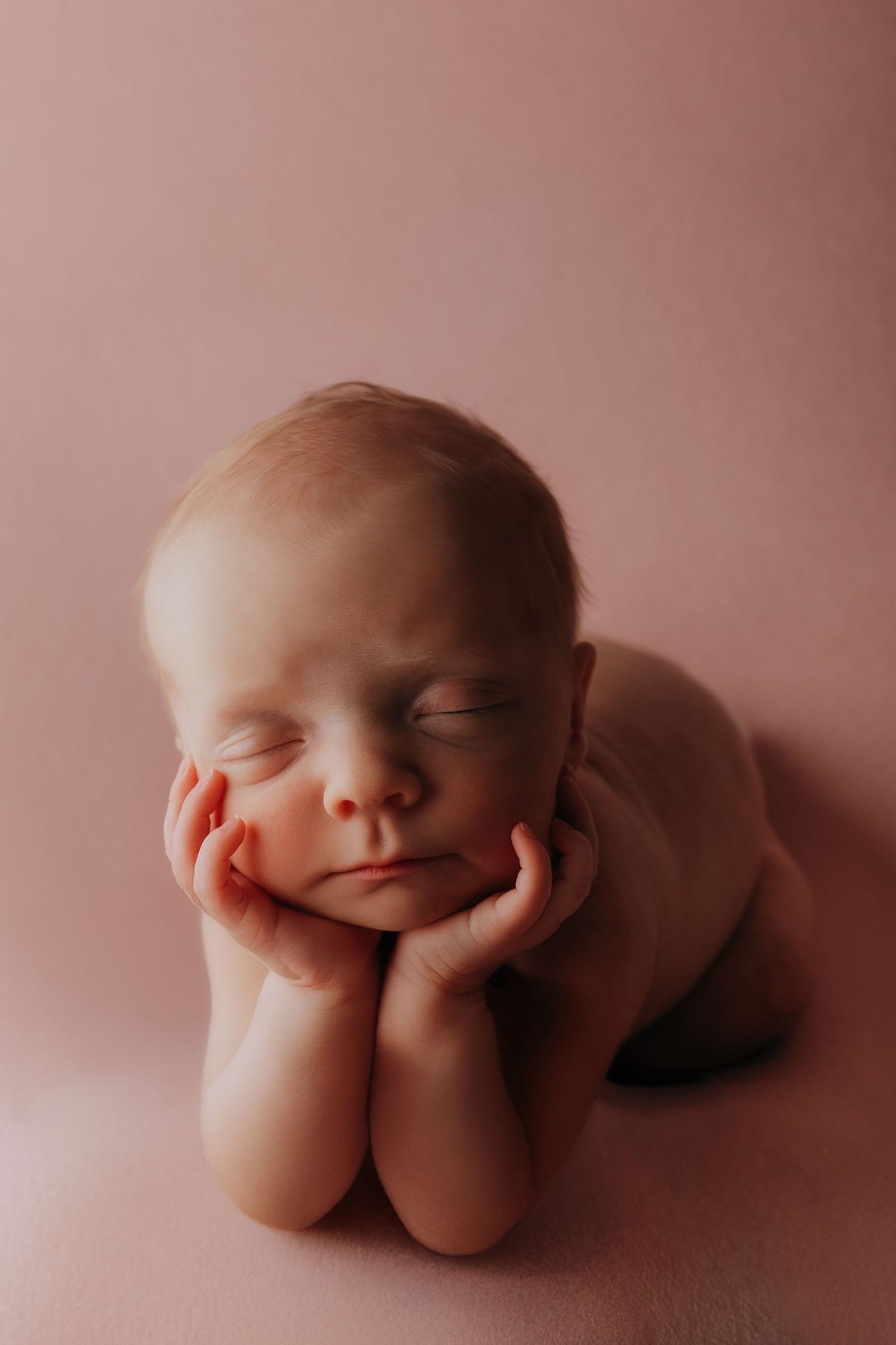 A series of five artistic photographs showing abstract flesh-toned forms against a soft pink background.