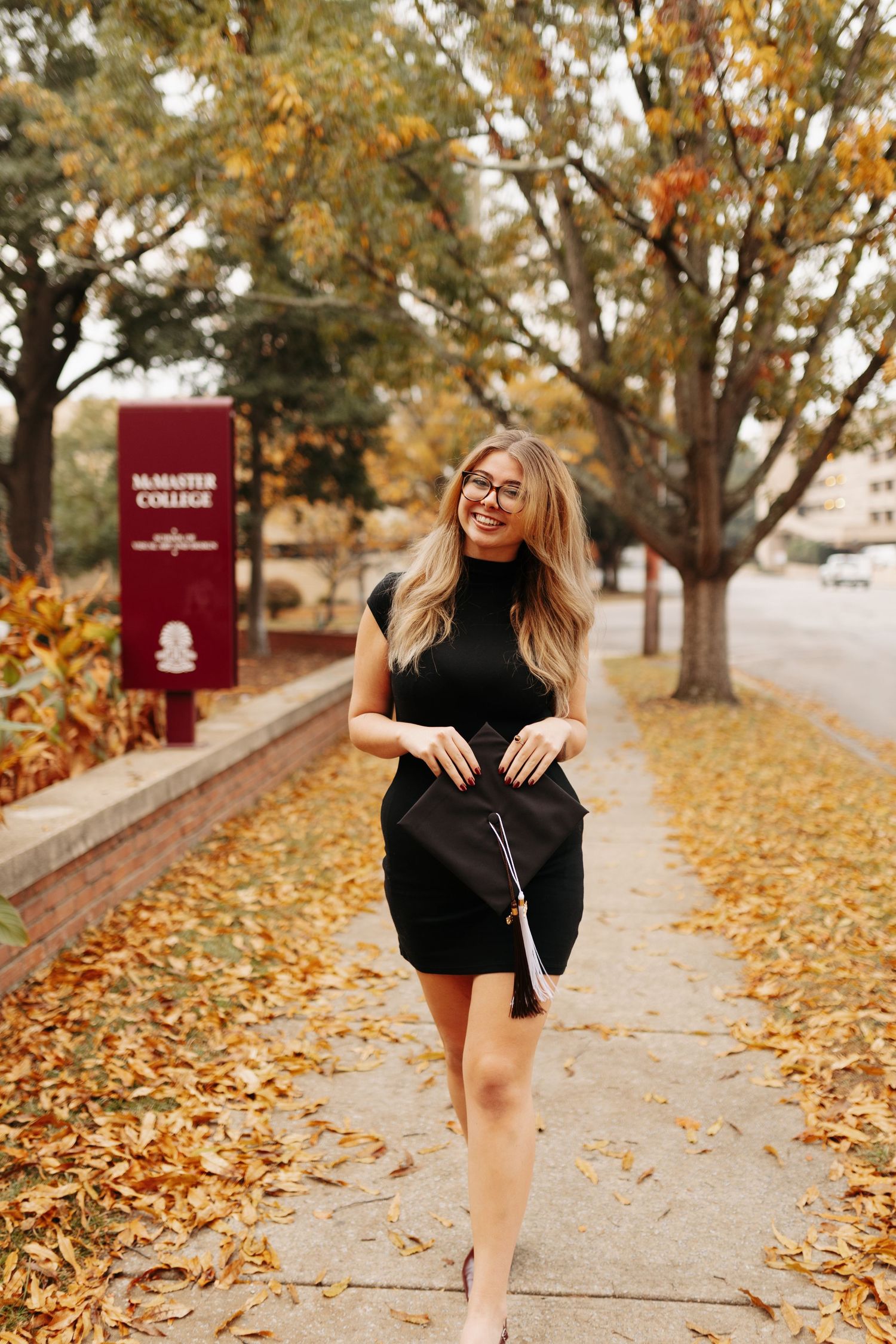 A series of autumn photos showing a person in a black dress posing playfully among fallen leaves on a sidewalk.