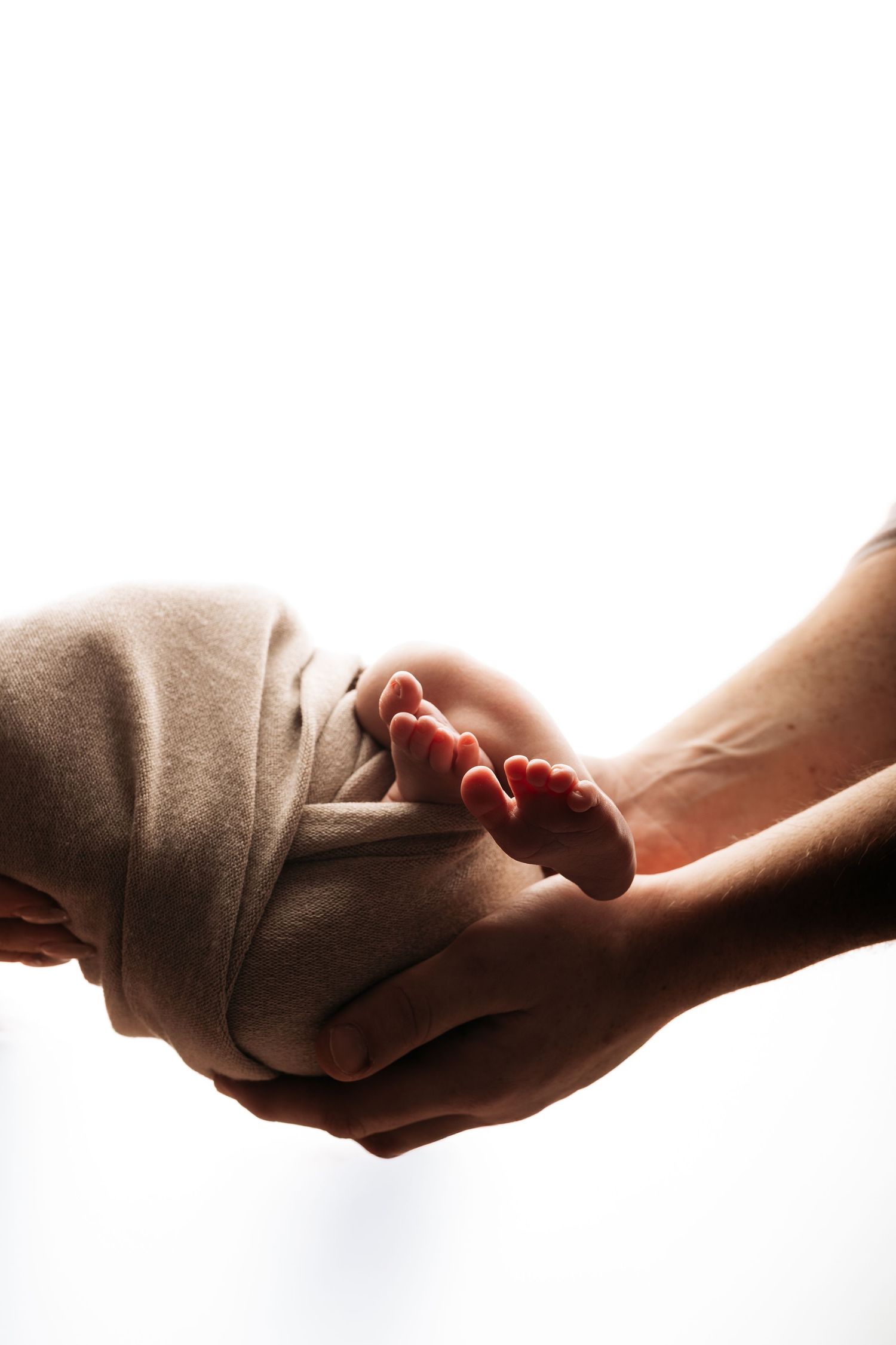 Four hands passing a baton in a relay sequence against a white background, symbolizing teamwork and succession.