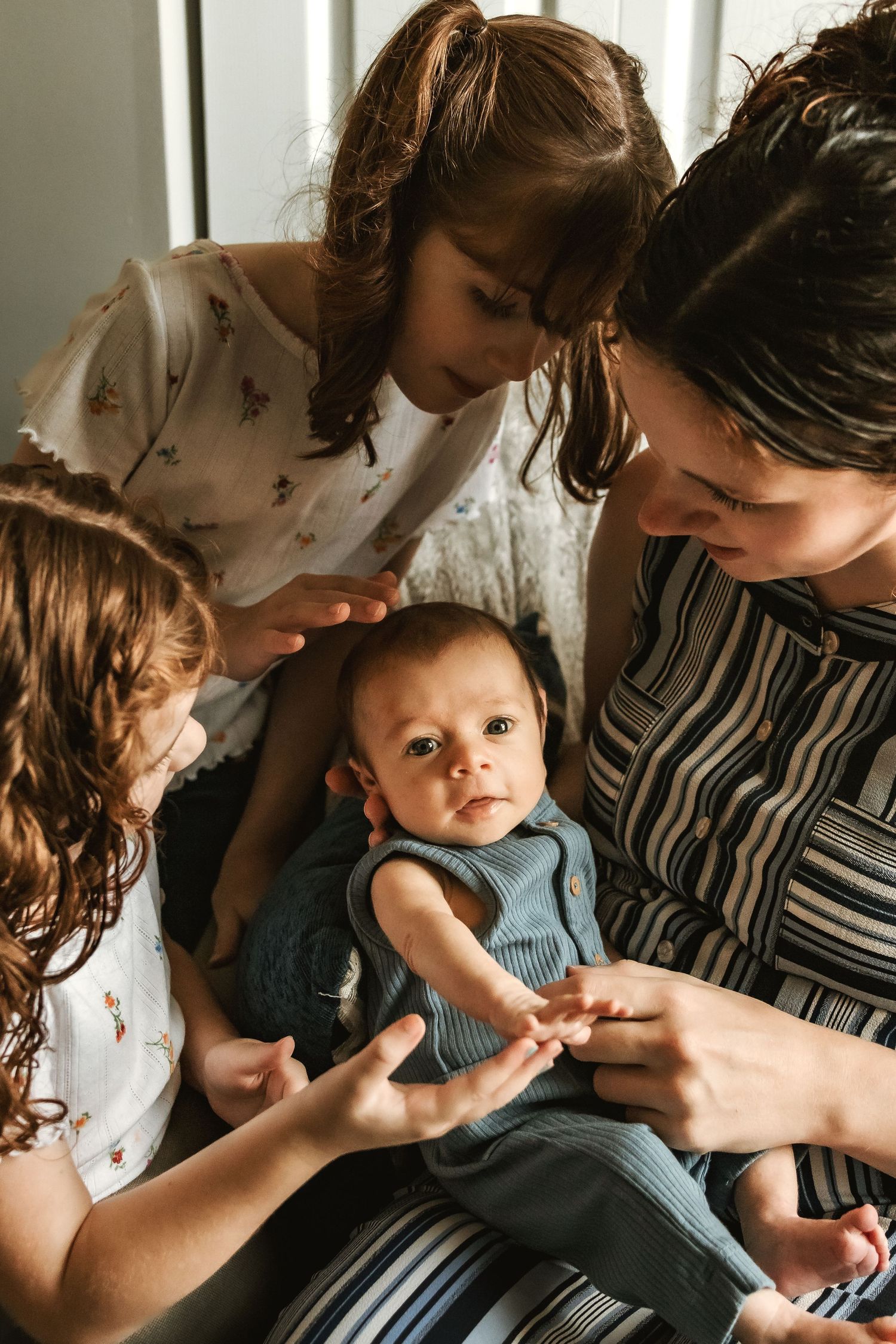 Tender family moment with baby in blue outfit.