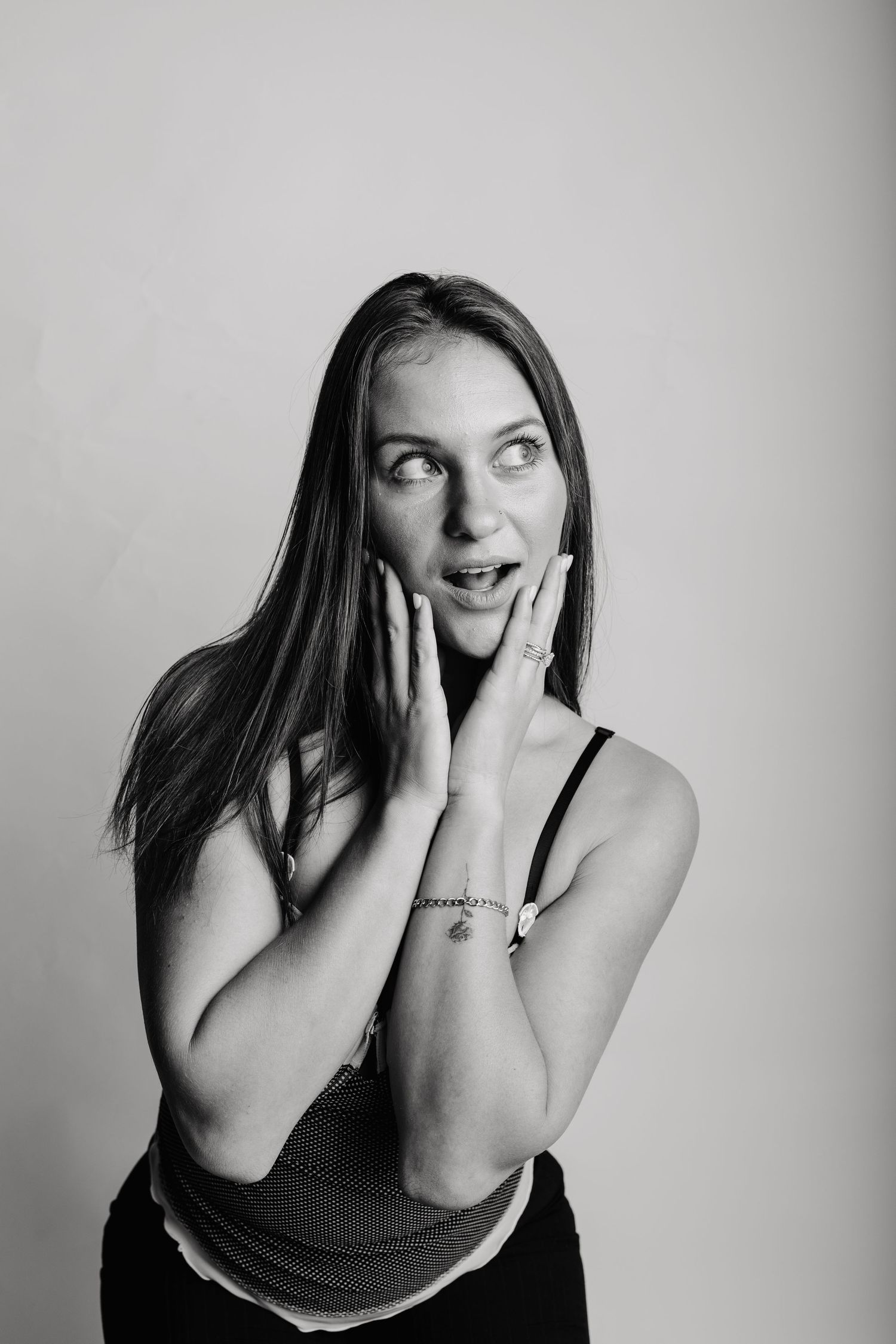 Black and white photo series showing emotional expressions with hands covering face in various poses.