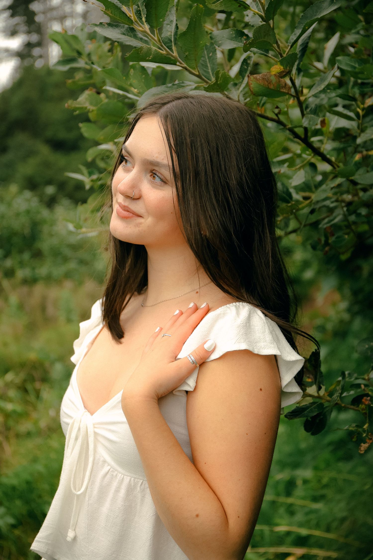 A sequence of outdoor portrait photos showing a person in a white top looking upward against a leafy background.