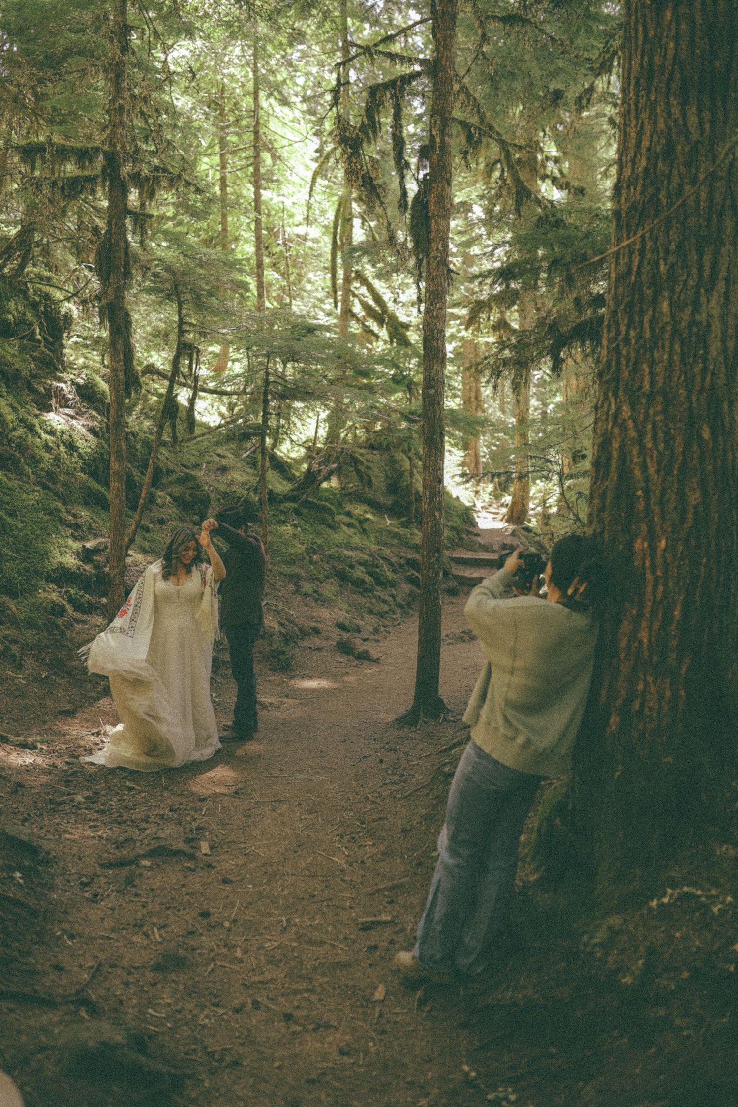 Wedding photo shoot in a serene forest setting with natural lighting.