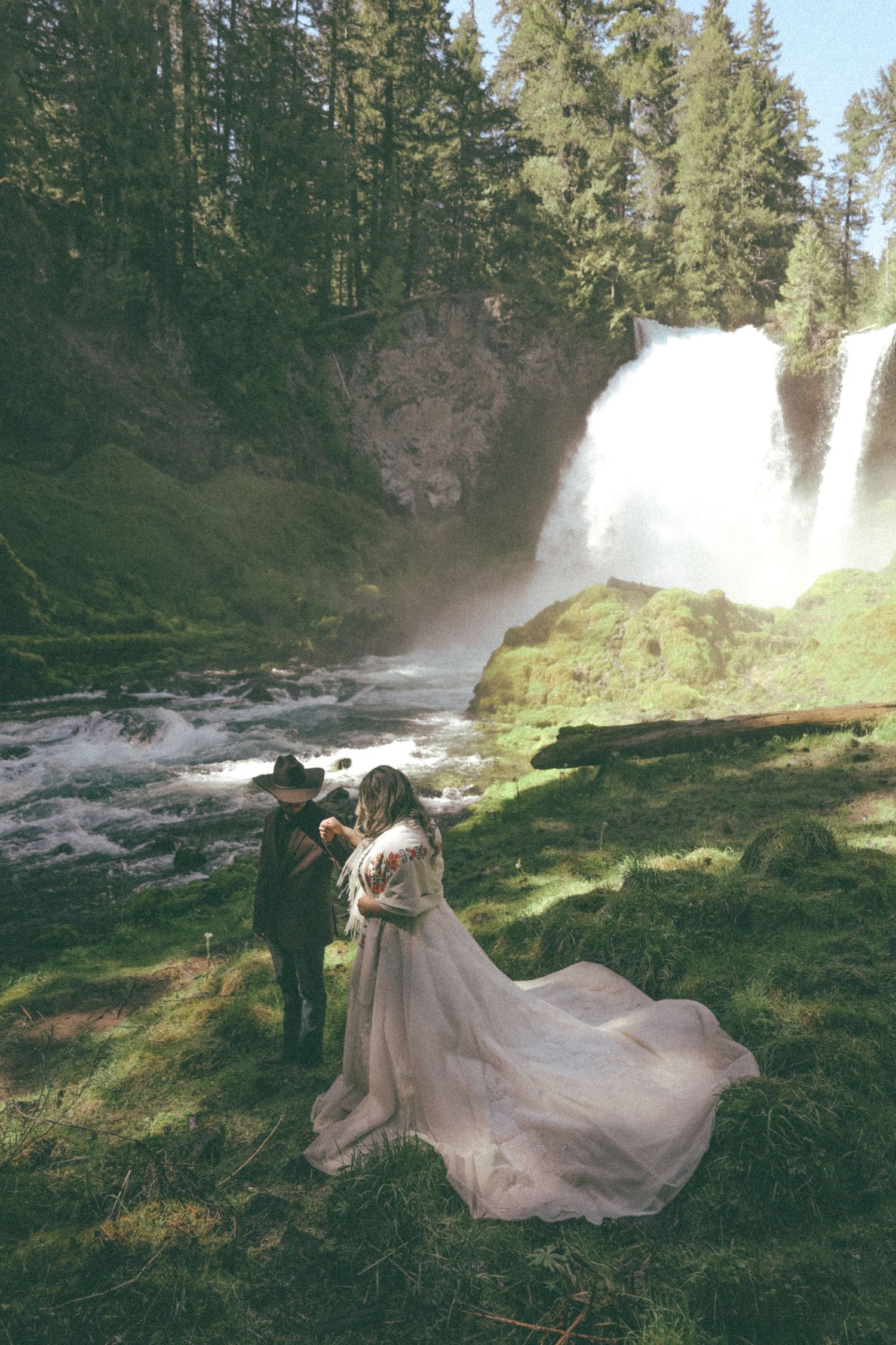 Artistic wedding photography sequence near a cascading waterfall showing movement and natural lighting.
