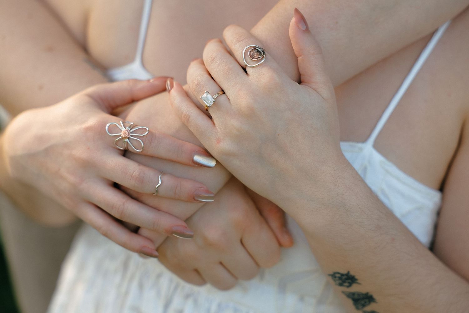 Close-up shots of hands with rings showing tender moments between a couple.