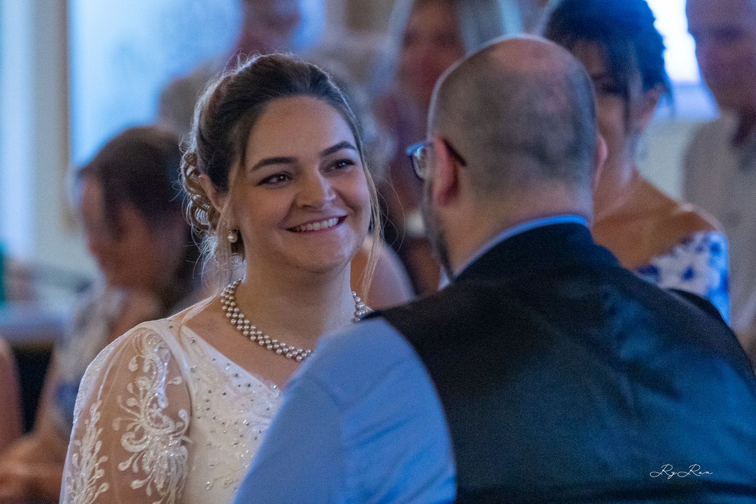 A bride and groom share an intimate moment during their wedding reception.