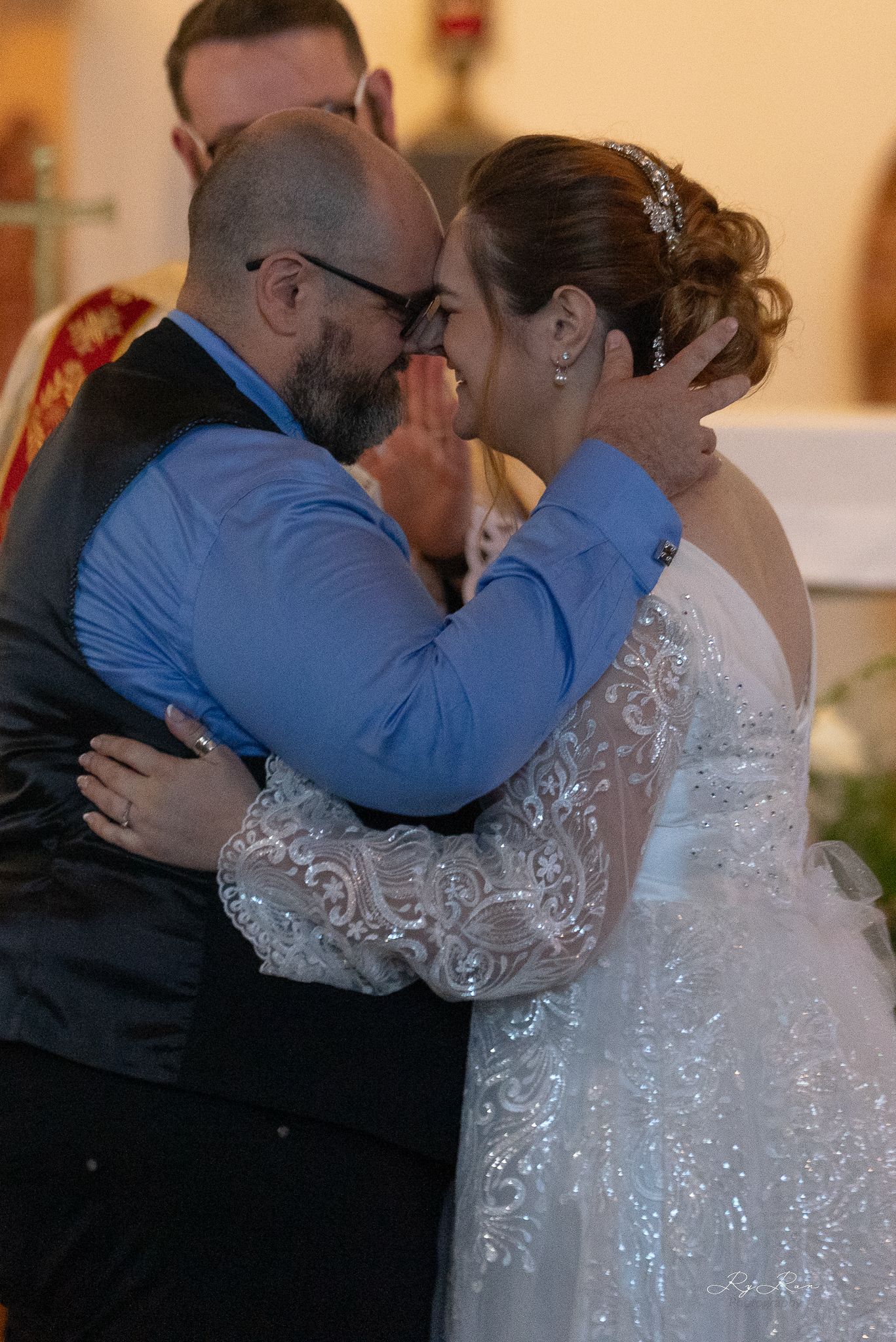 A tender embrace shared between a couple during their wedding ceremony.