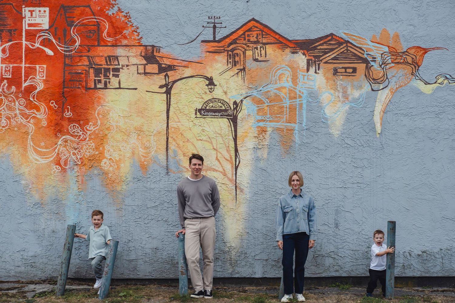 A sequence of photos showing a person painting an orange and blue mural on a wall in multiple stages.