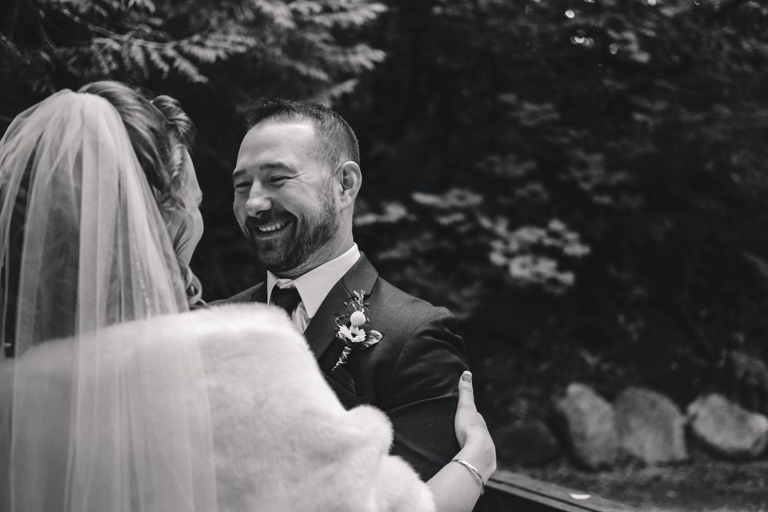 A happy couple shares an emotional first look moment during their outdoor wedding ceremony.
