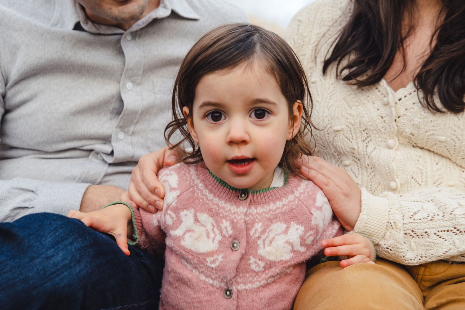 A series of candid photos showing a young child in pink clothing sitting and playing.