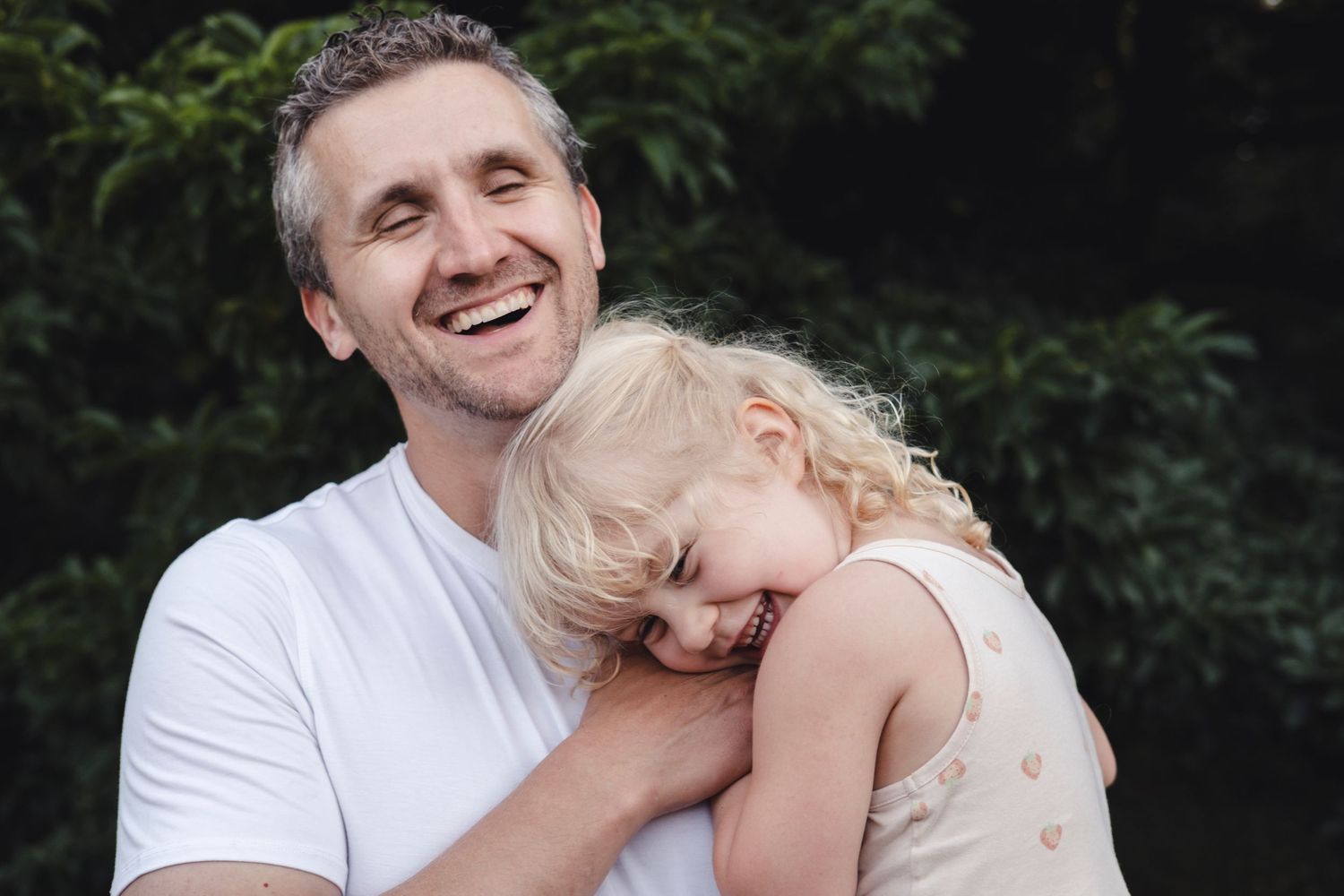 A series of candid black and white photos showing tender moments between a parent and child.