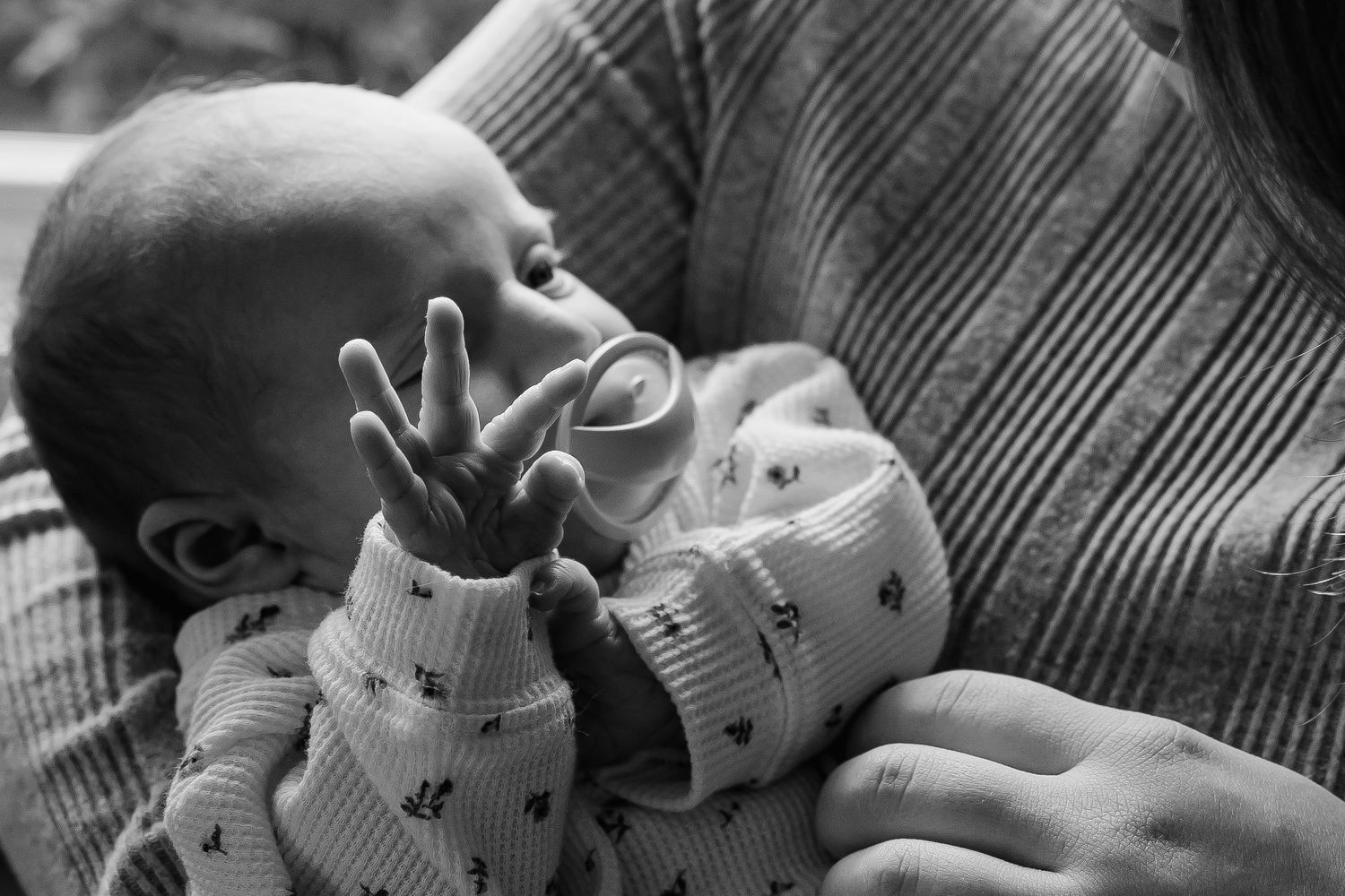 Black and white photo series showing a sleeping baby with a stuffed animal bunny toy in a peaceful slumber.