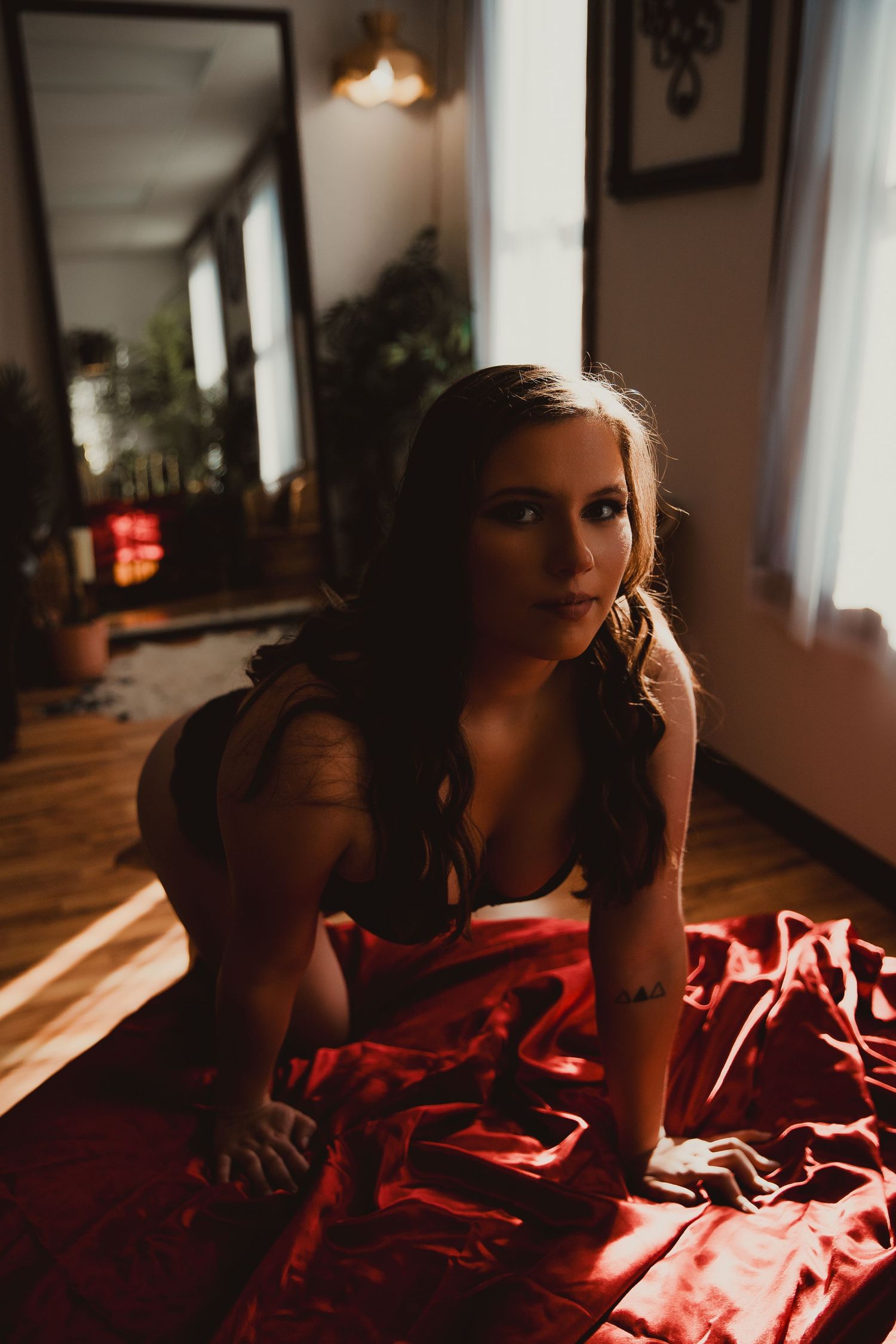 A moody sequence of silhouettes against warm sunlight streaming through windows in a dimly lit interior space.
