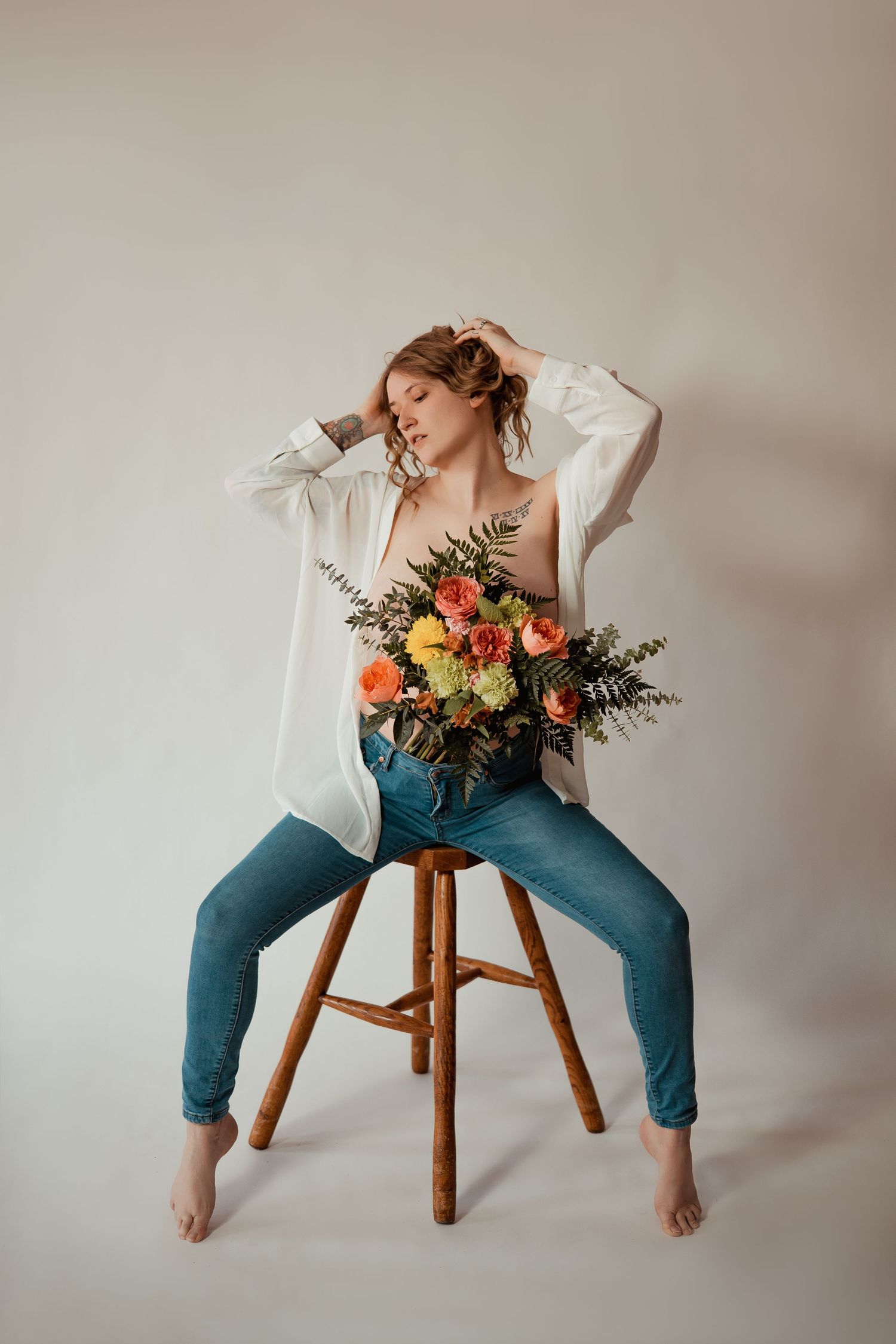 A series of artistic poses on a wooden stool with a colorful floral bouquet and white blouse against neutral backdrop.