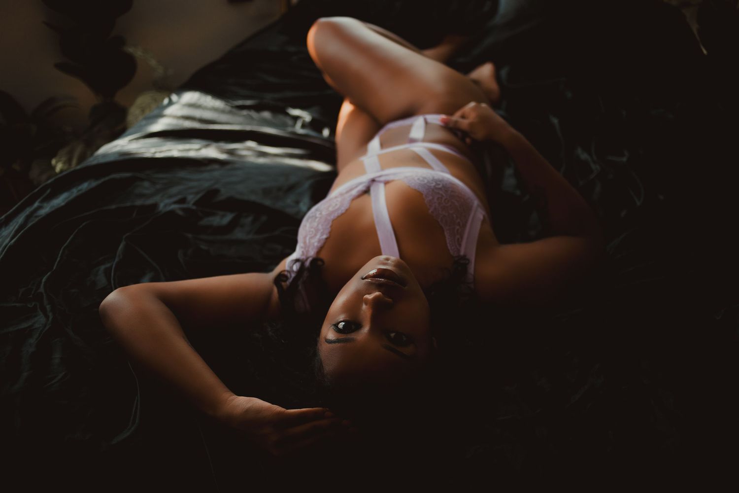An artistic boudoir photography session featuring dramatic lighting and intimate portraiture. boudoir