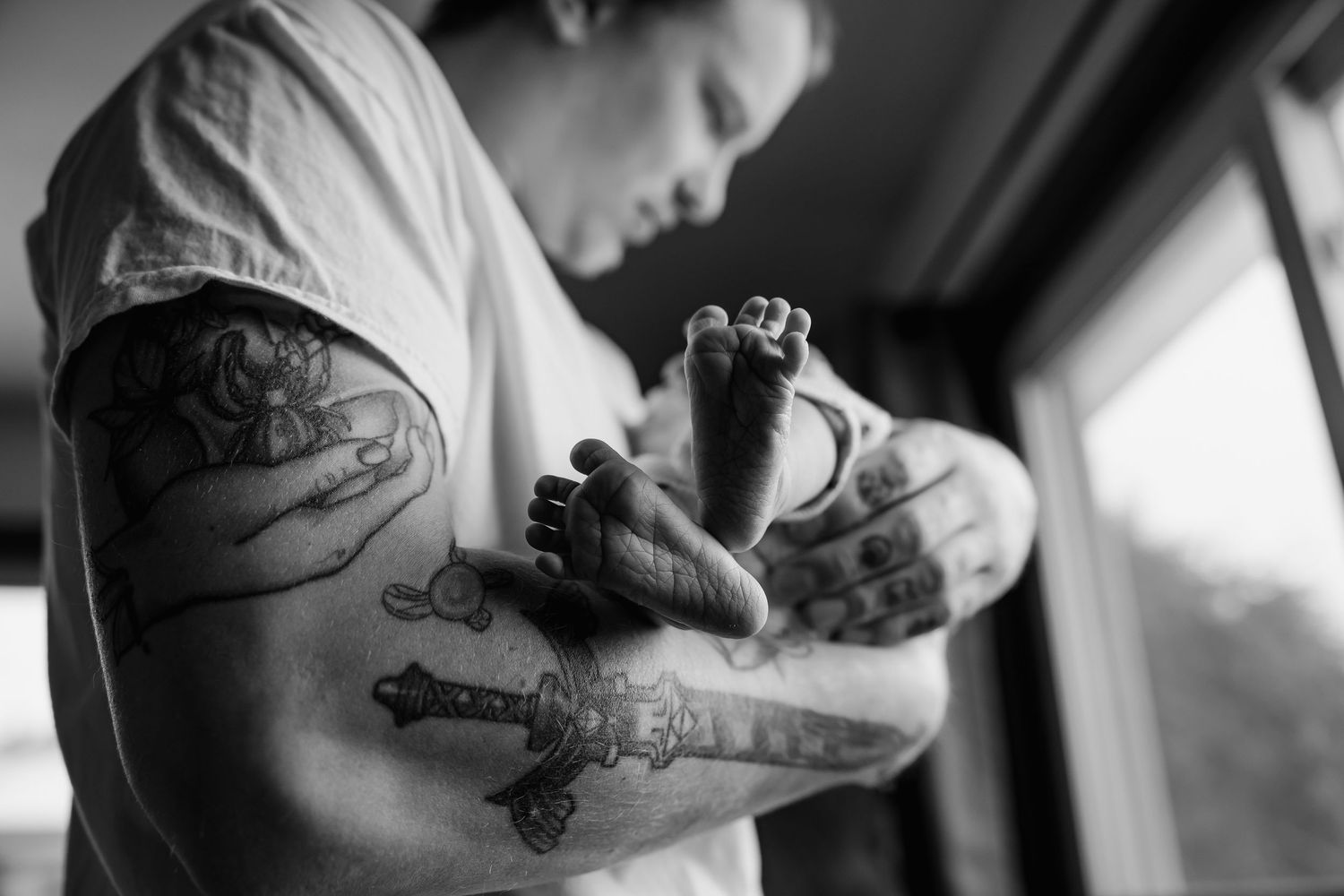 Black and white photo series showing close-up shots of arm tattoos in natural lighting.