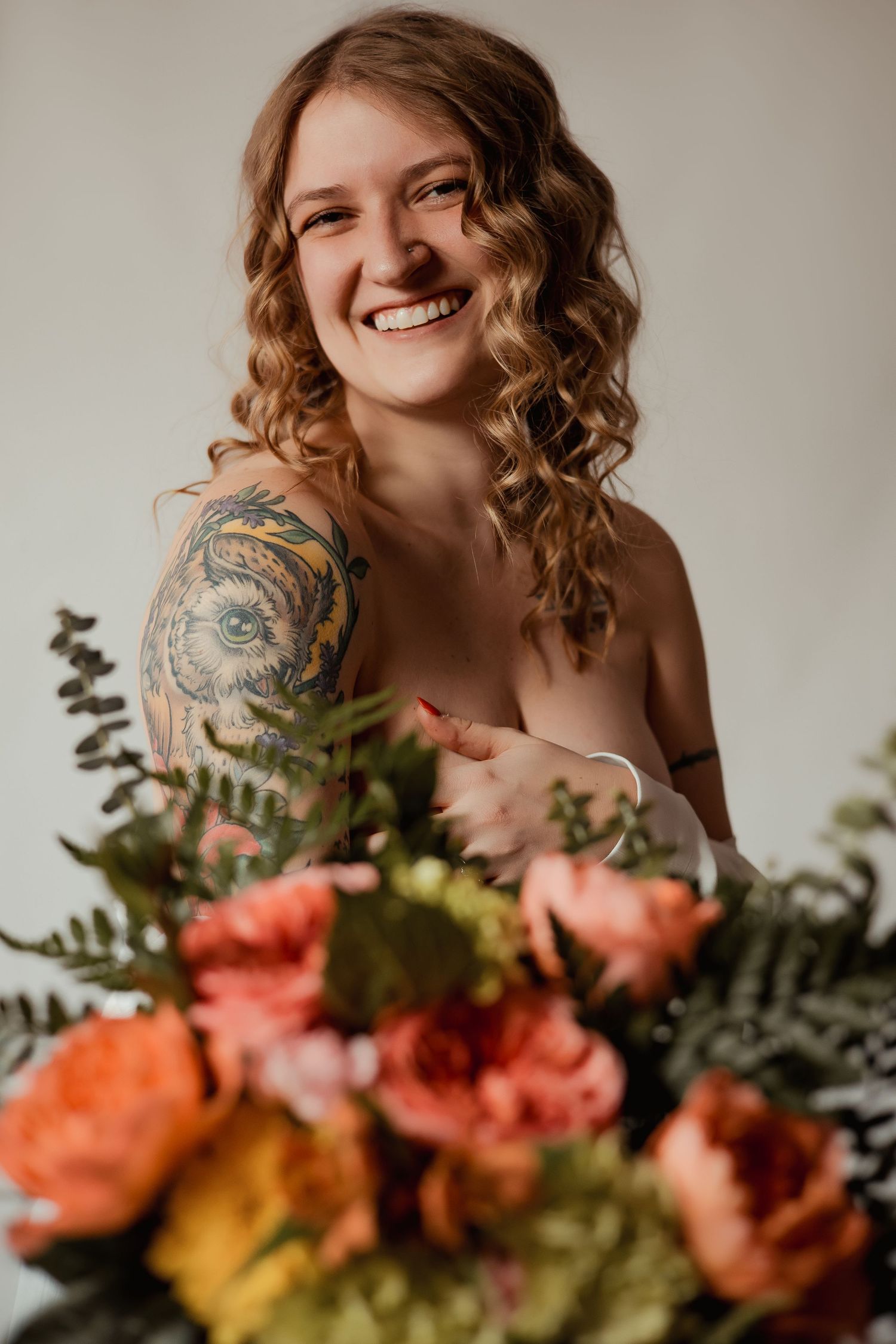 A series of close-up shots showing curly hair and floral arrangements with orange and pink blooms against a neutral backdrop.