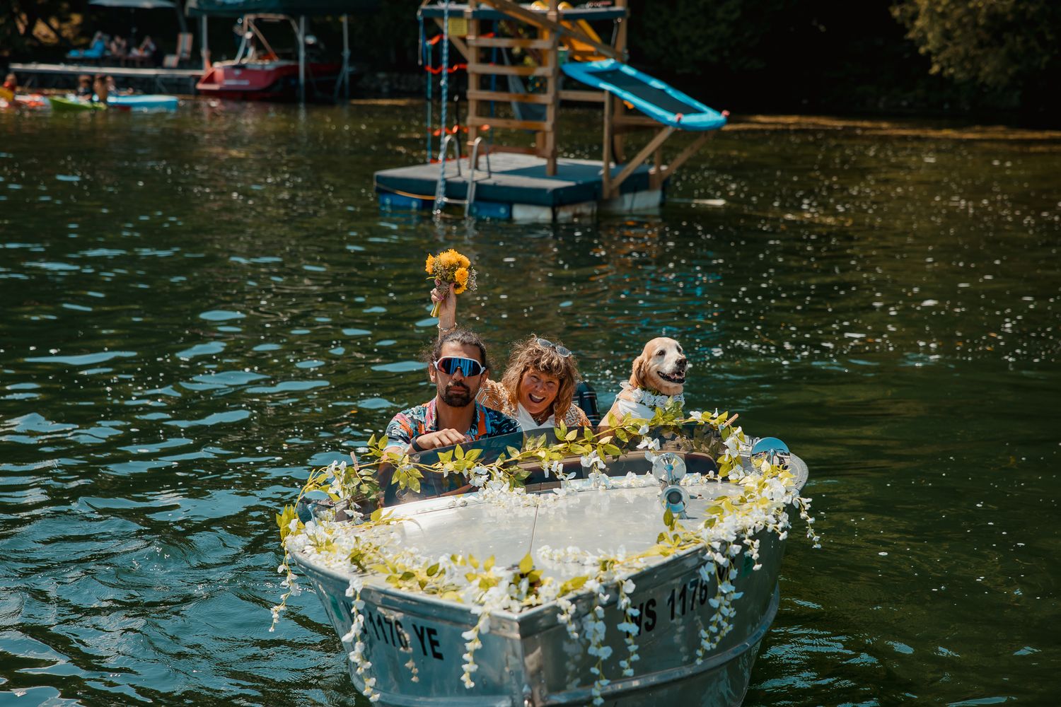 Brightly decorated homemade cardboard boats race across the lake during a summer festival event.