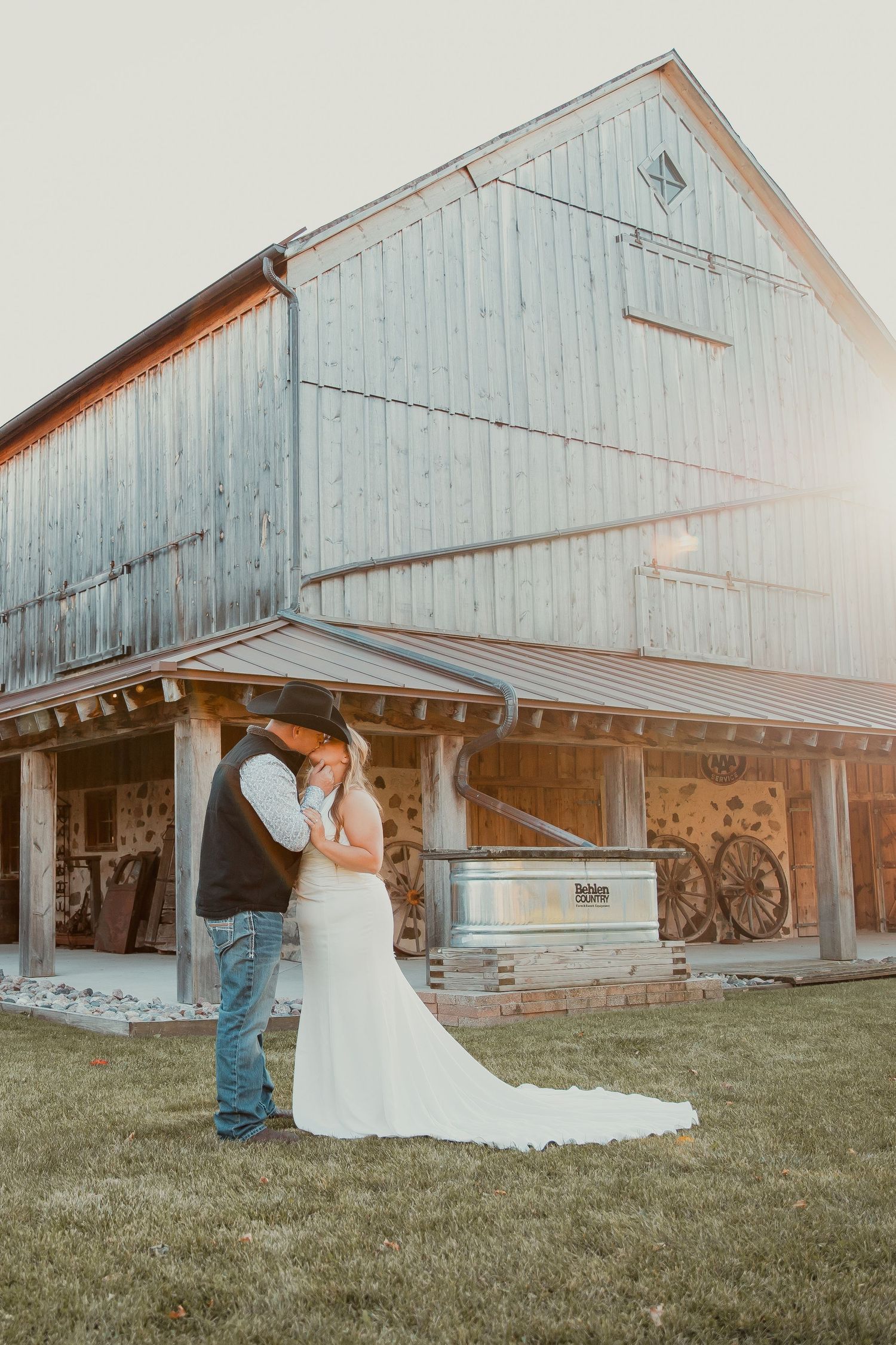 Rustic barn wedding photo with white dress against weathered wooden structure. engagement couple wedding