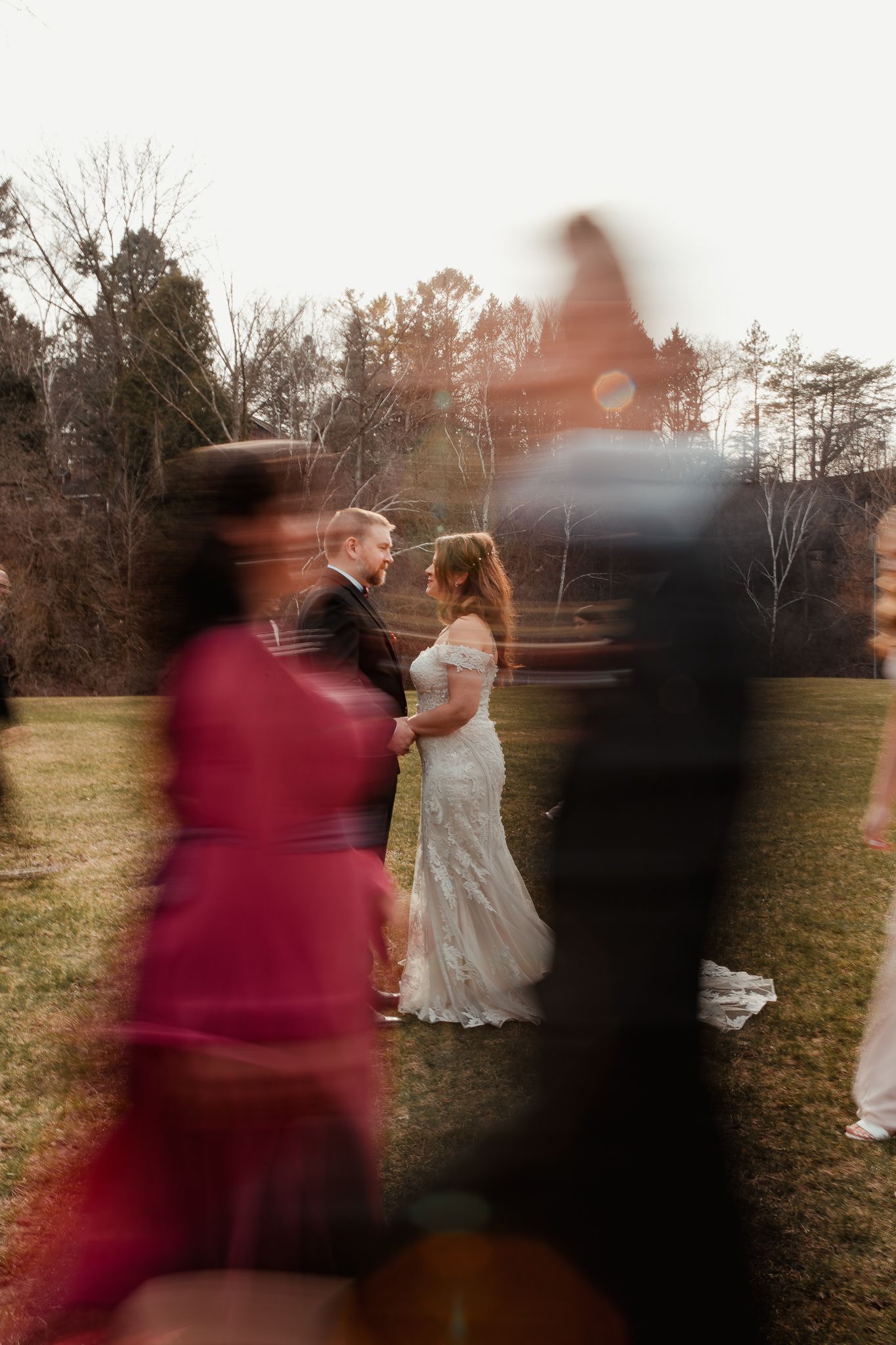 A dreamy wedding ceremony photo with blurred guests in the foreground. wedding