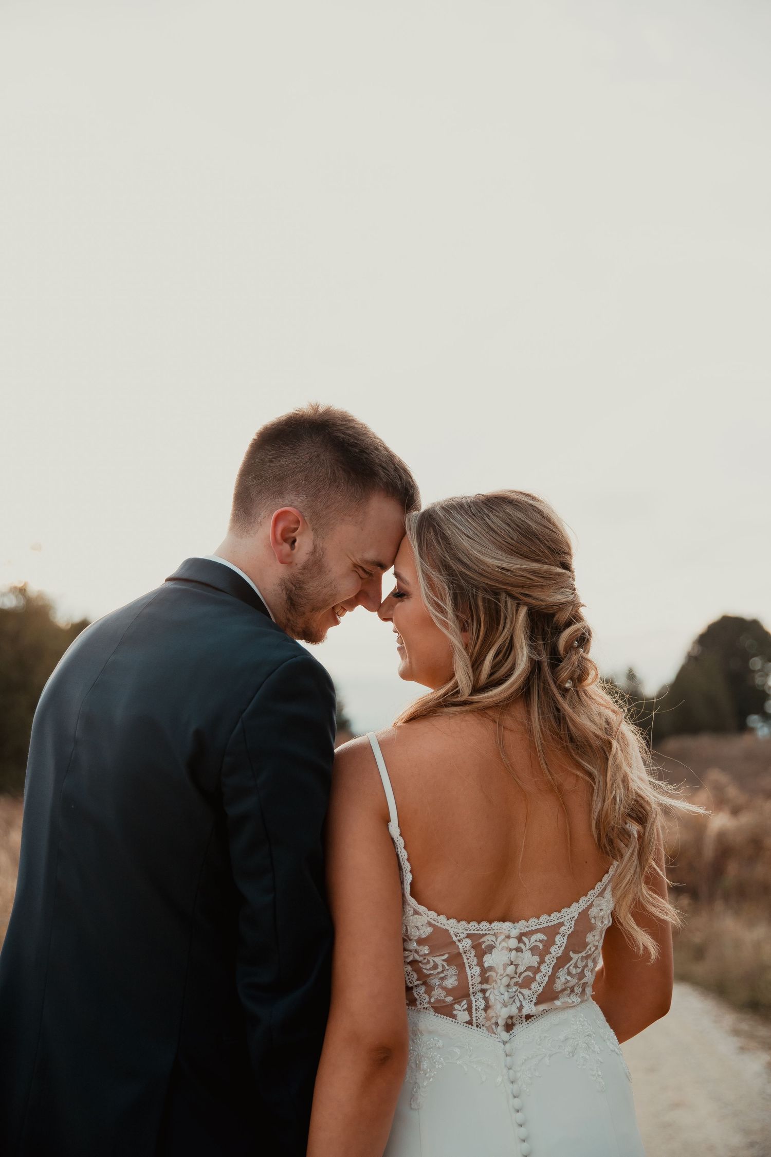 Romantic wedding couple sharing an intimate moment on a dirt path. wedding