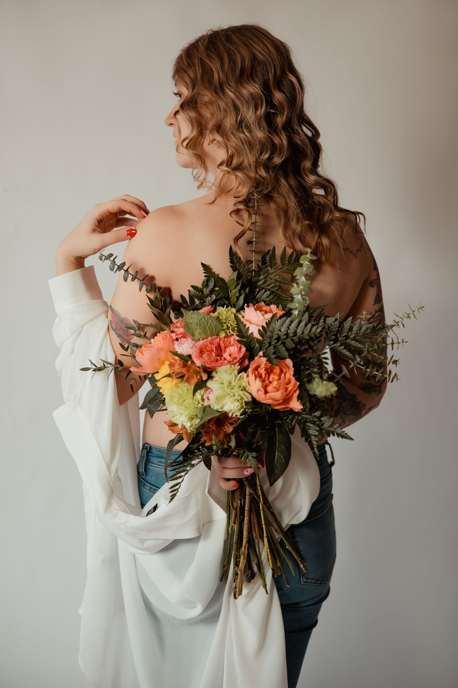Artistic photo series showing a bouquet of coral roses and greenery with flowing white fabric against neutral backdrop.