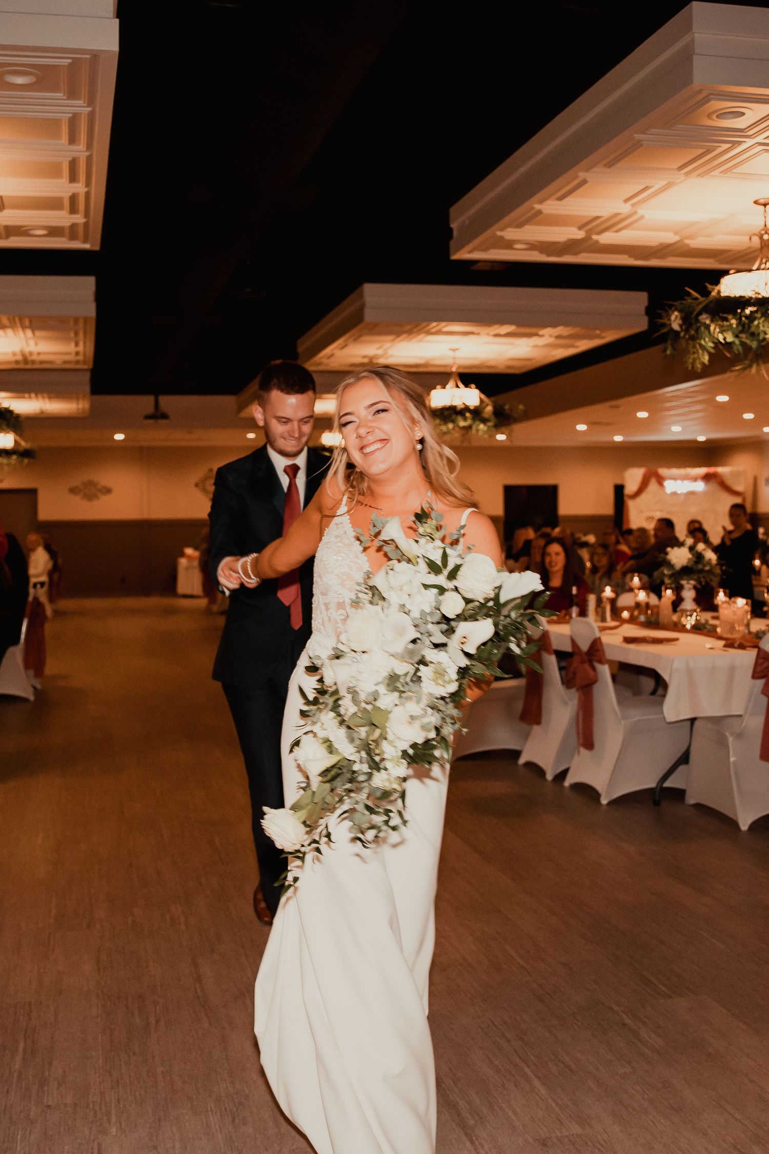 Wedding celebration in a reception hall with decorative lighting and white table settings. wedding