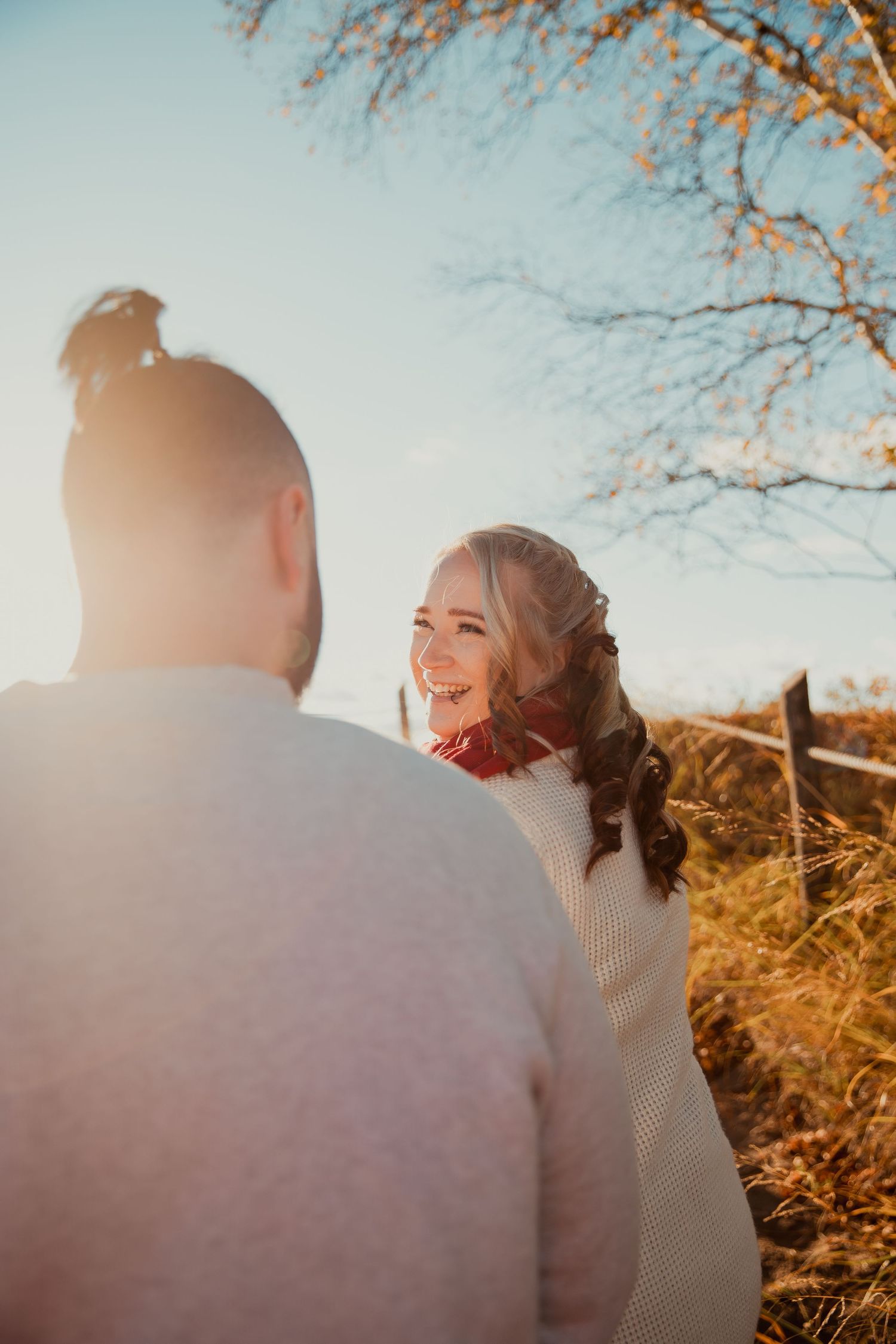 Golden hour engagement photo with warm sunlight creating a romantic backlit silhouette. couples engagement