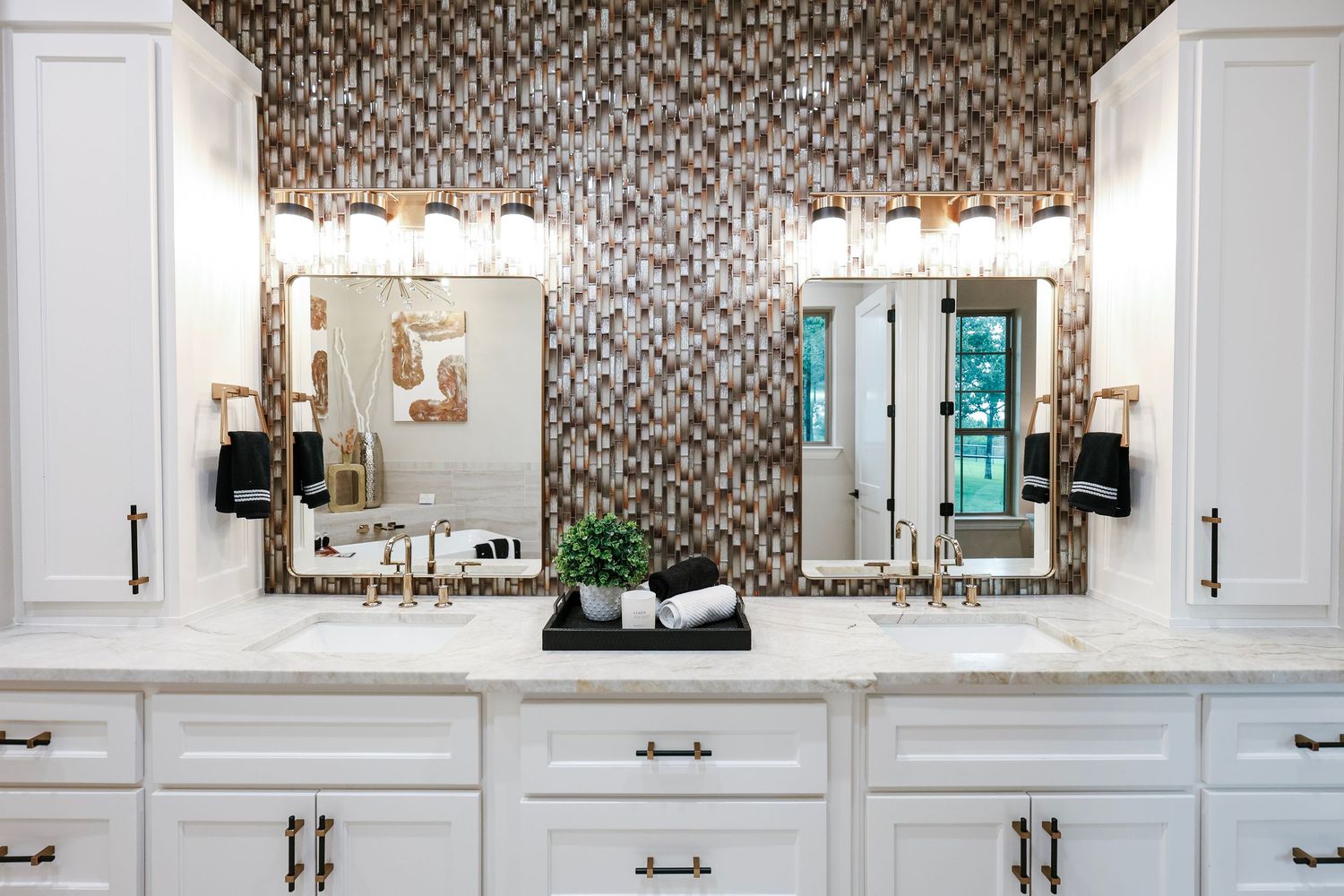 Luxurious bathroom with patterned wallpaper and white built-in cabinets.