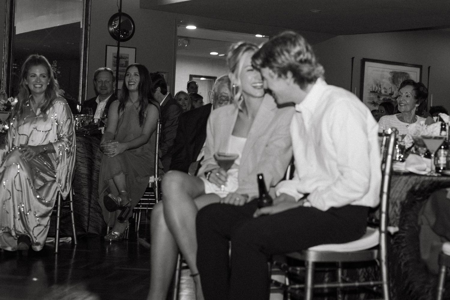 Black and white photos of guests dancing and celebrating at an indoor reception party.