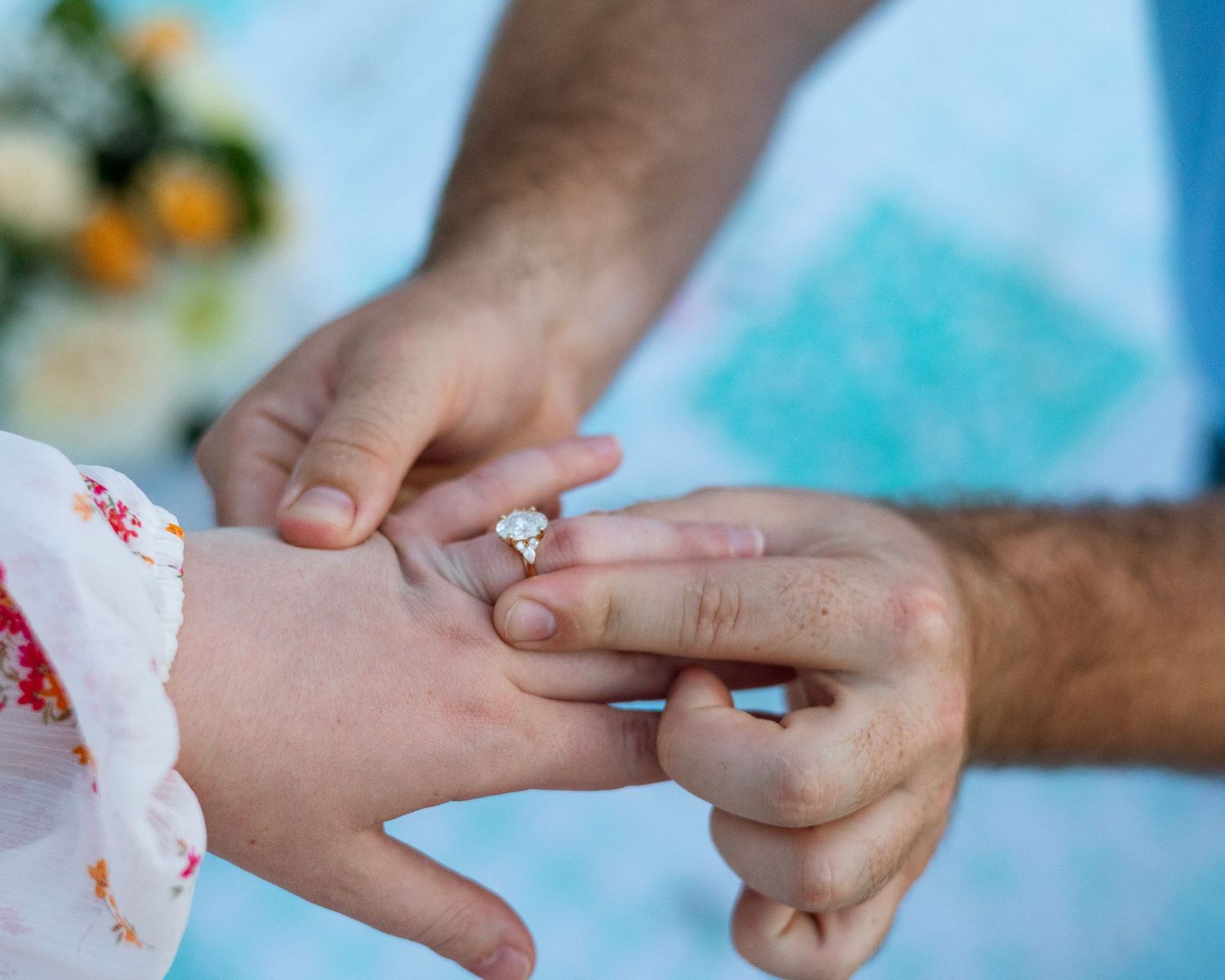 Close-up shots of hands during a romantic proposal moment with an engagement ring.