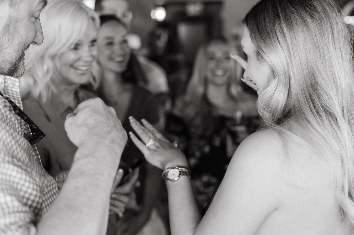 Black and white photos capturing genuine laughter and joy during a special moment.