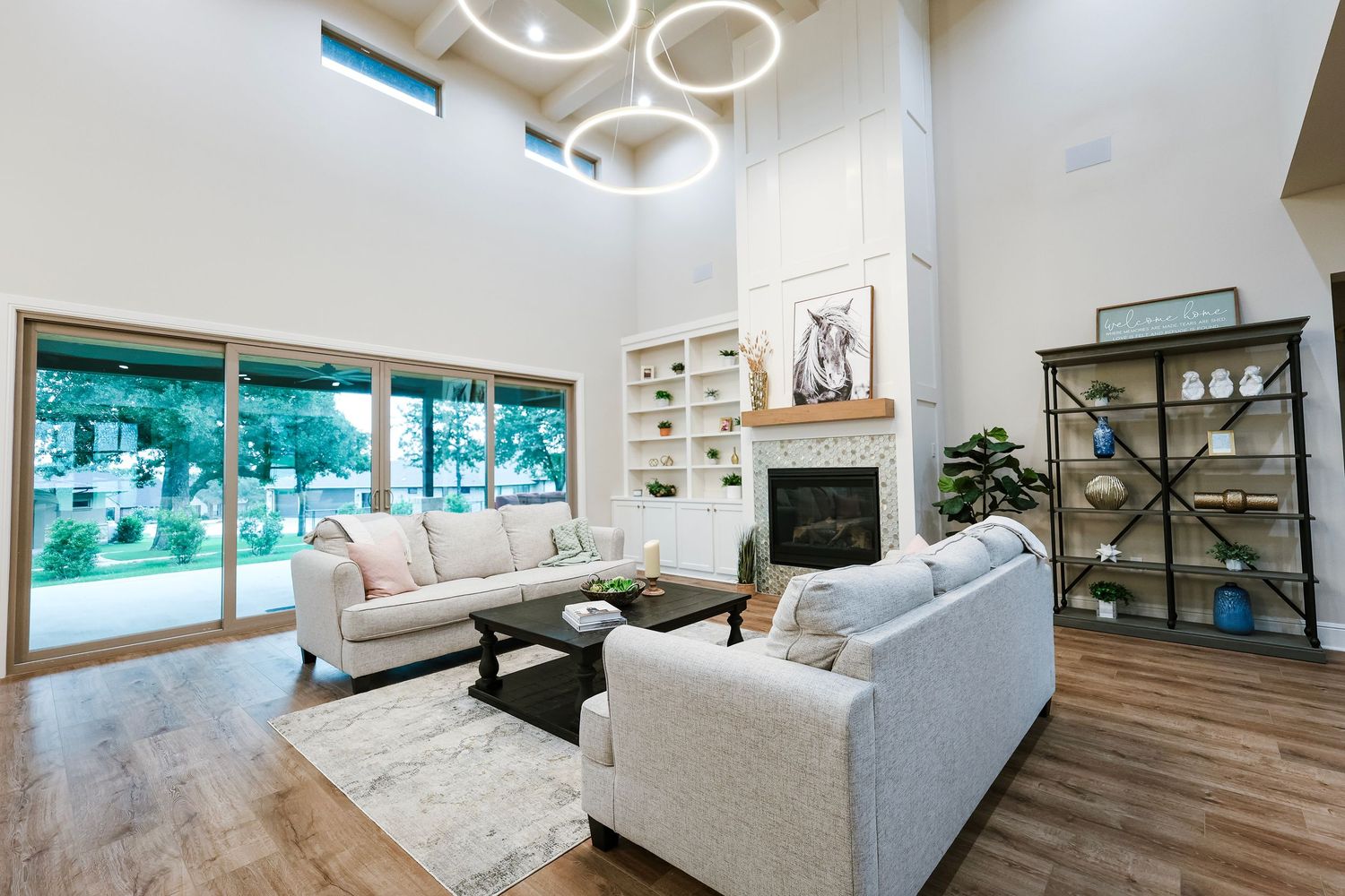 Modern apartment interior with sleek white walls, hardwood floors, and large windows showcasing a bright, minimalist design.