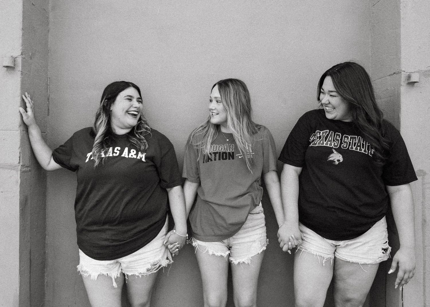 Black and white portrait series of friends posing casually against a wall.