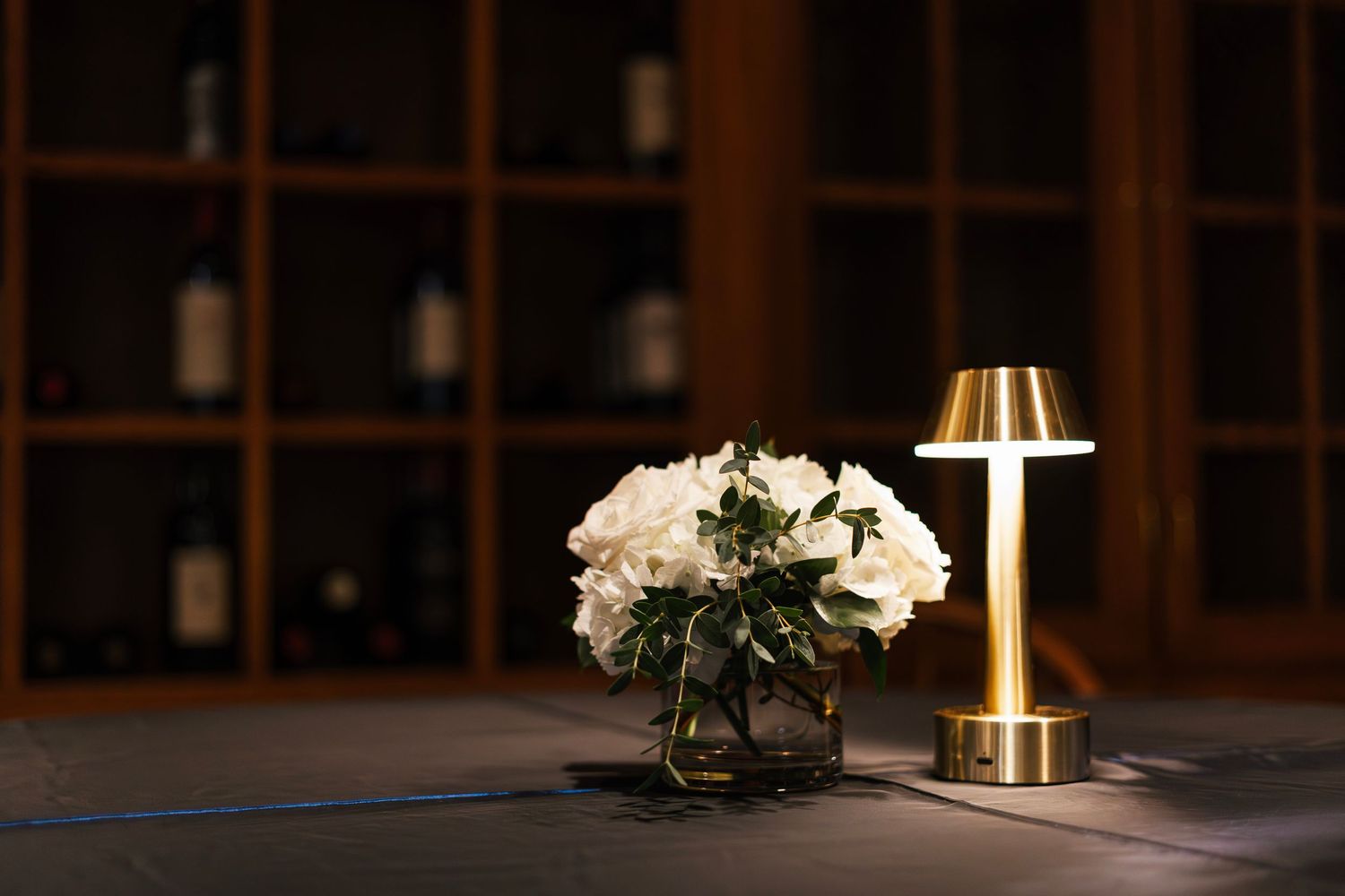 Elegant indoor venue with warm lighting and wooden beams creating a cozy rustic atmosphere.