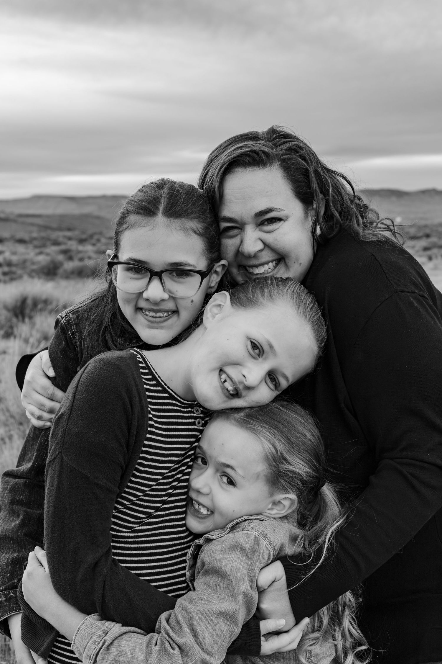 mom hugs three daughters