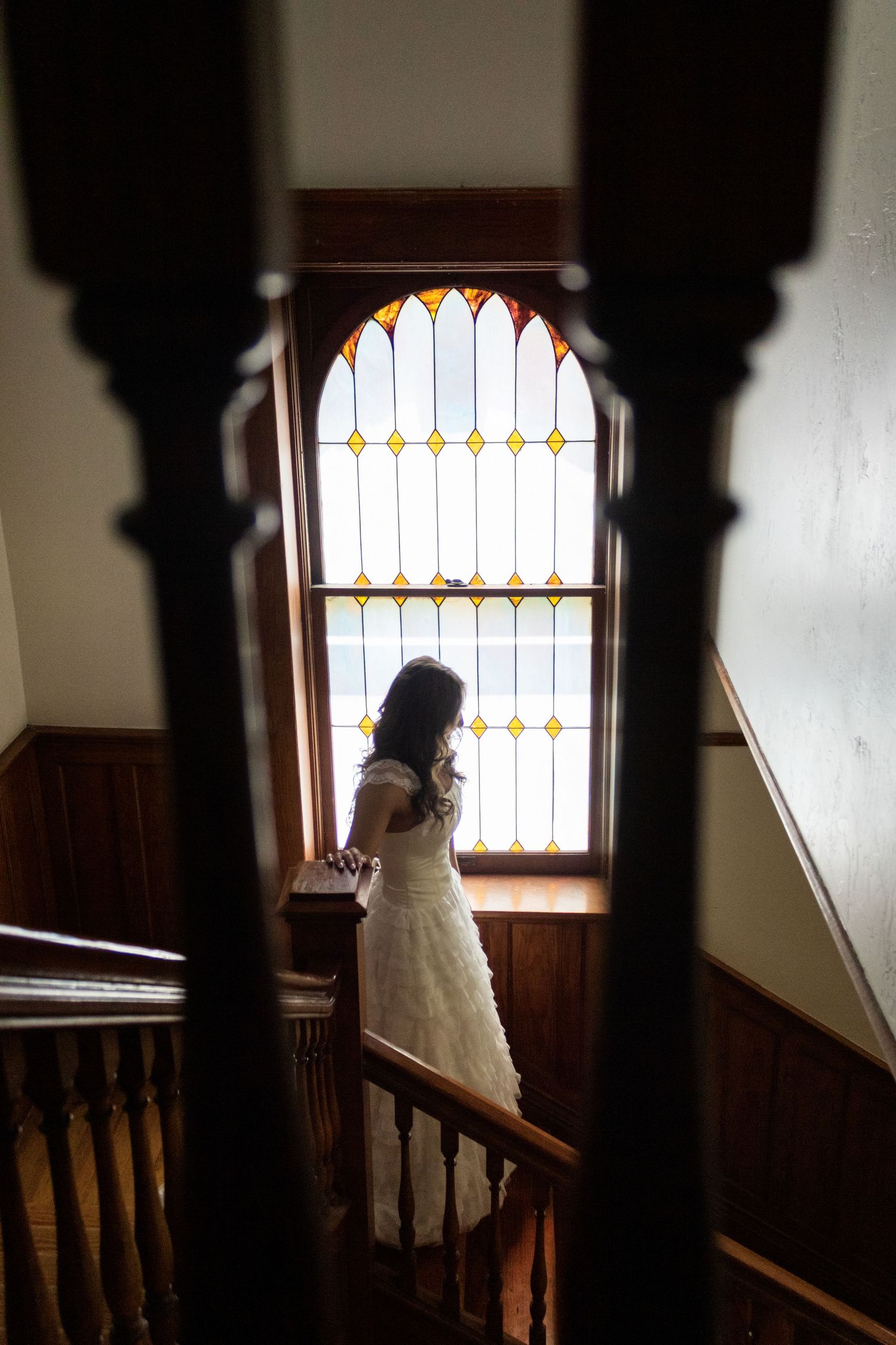 Bride stops on the stairs.