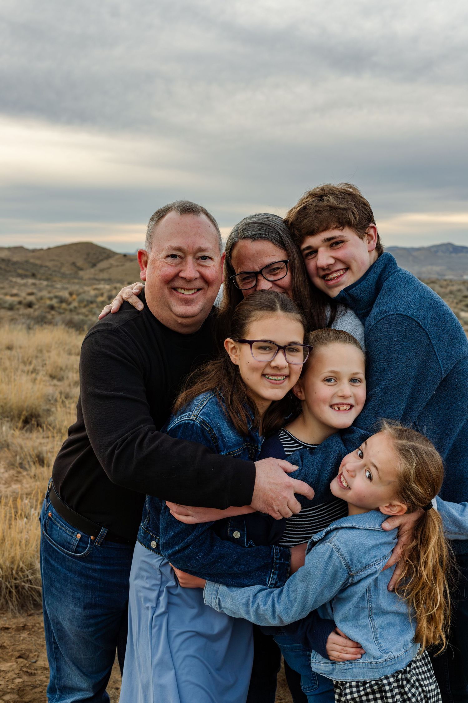 grandparents have group hug with grandkids