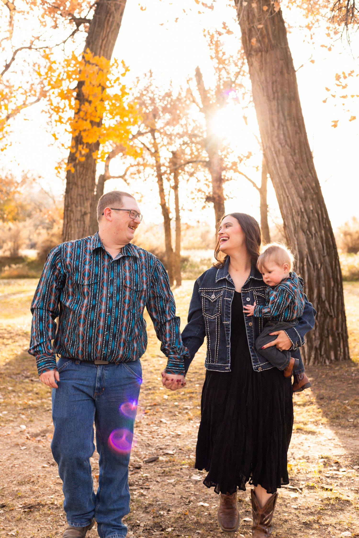 mom and dad look at eachother while baby looks at camera