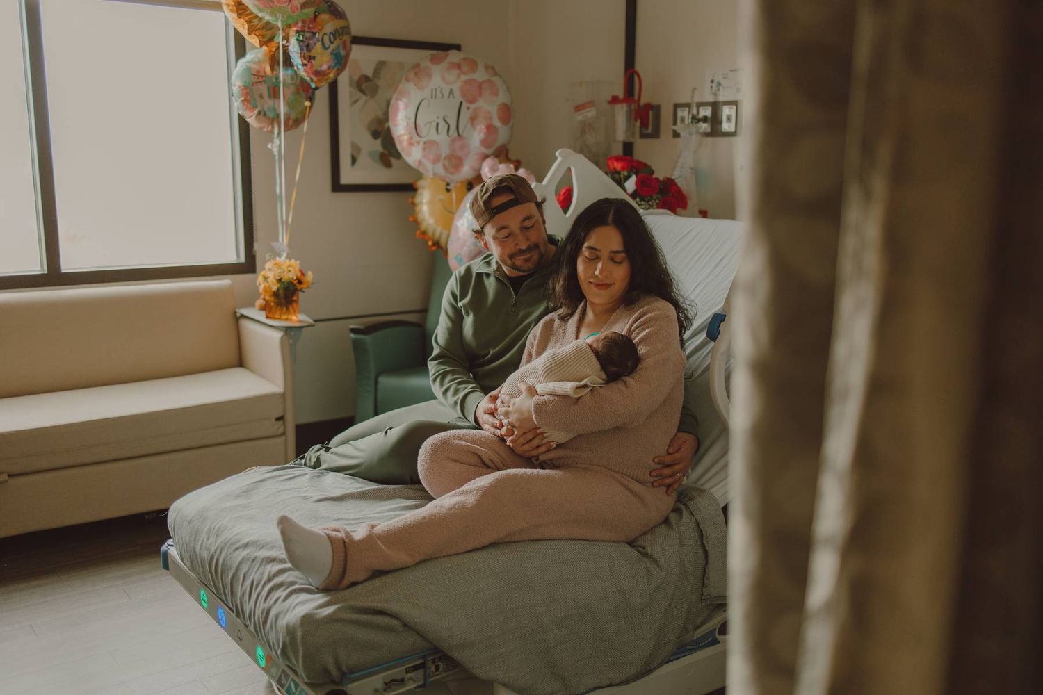 Lifestyle Fresh 48 photography of new parents holding their newborn baby shortly after birth in the hospital.