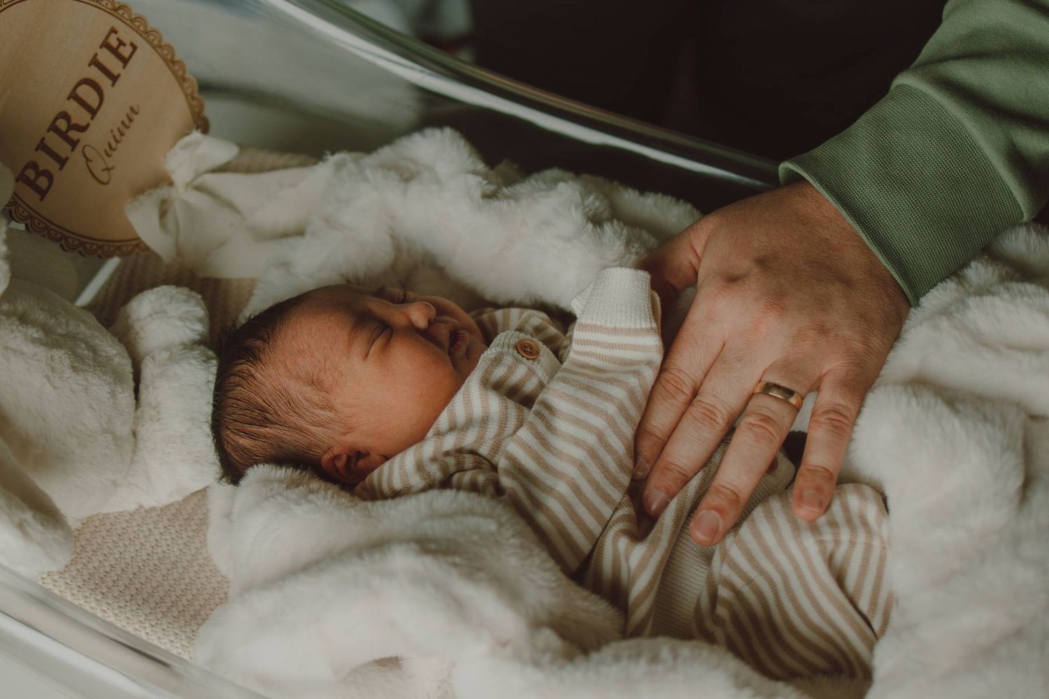 Father holding his newborn baby during a heartfelt Fresh 48 photography session in a Dallas hospital.