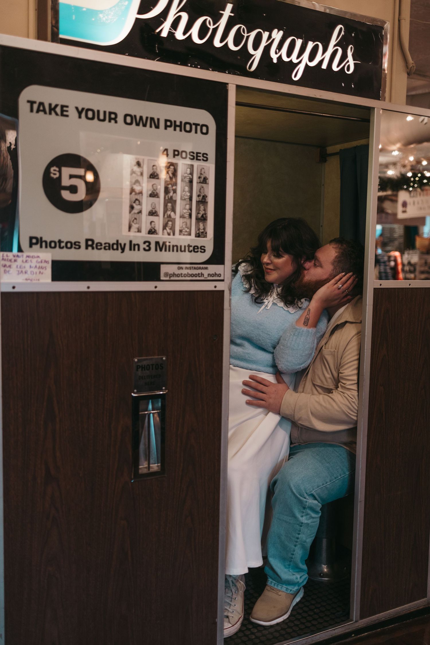 A vintage photo booth setup with multiple booths and signage advertising 3-minute photo development service.