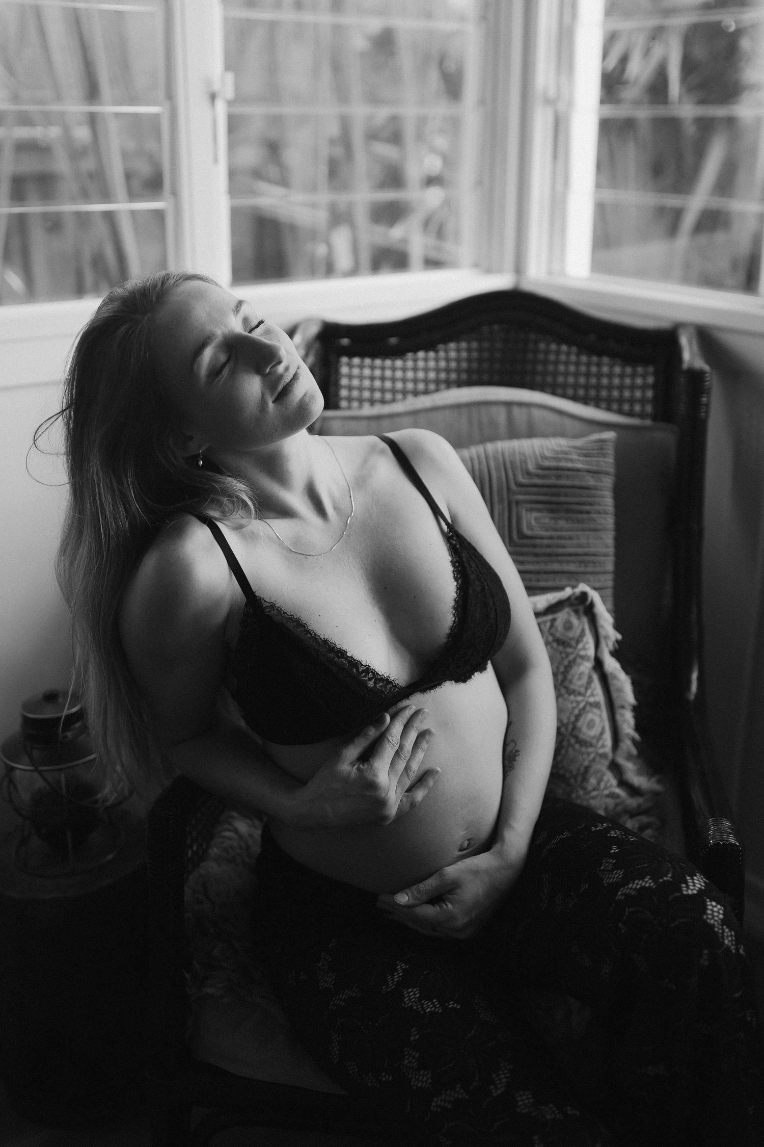 Artistic black and white series showcasing a figure in dramatic poses against soft window light.