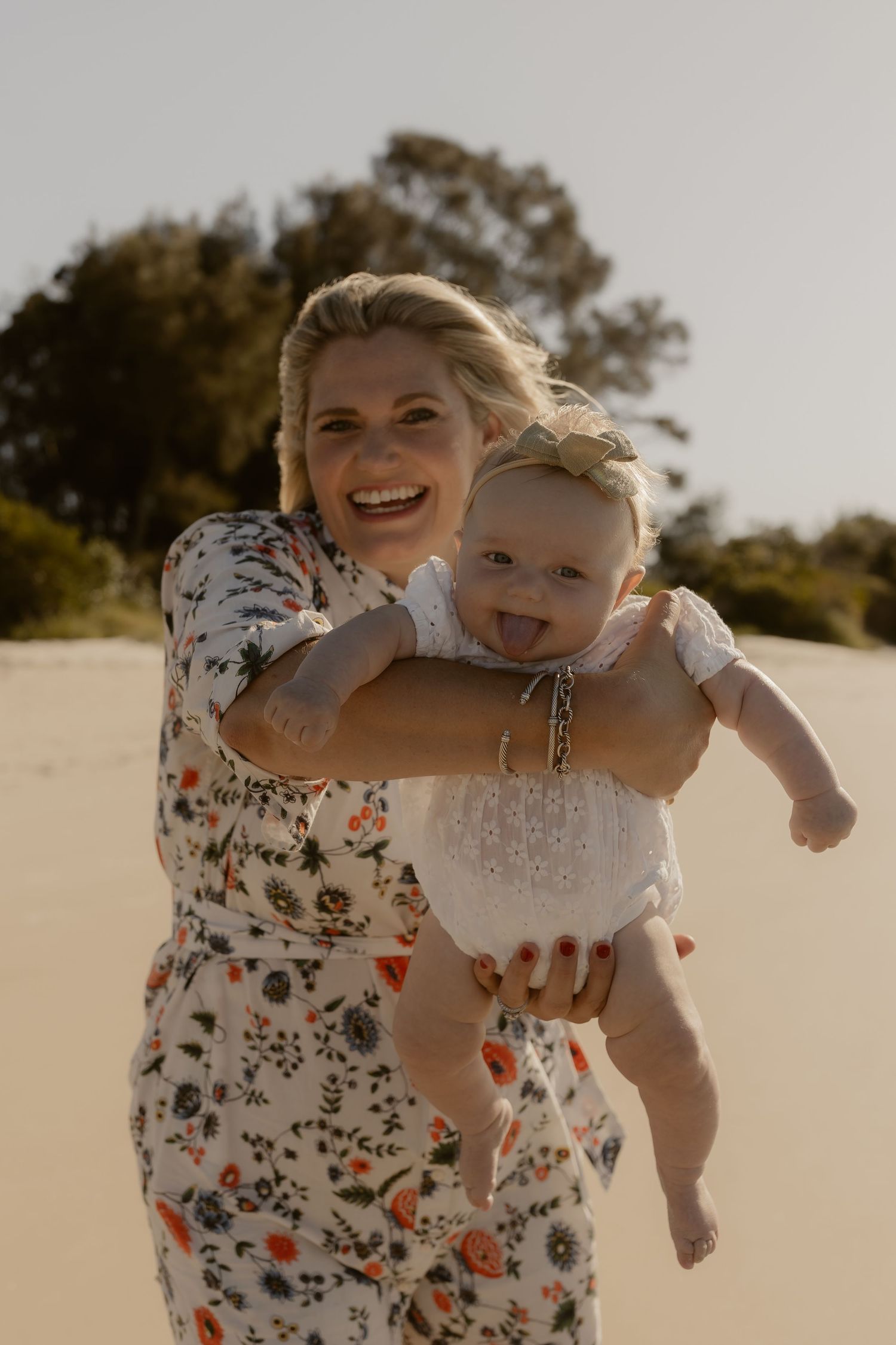 Candid moments of joy and laughter captured during a beach photoshoot.
