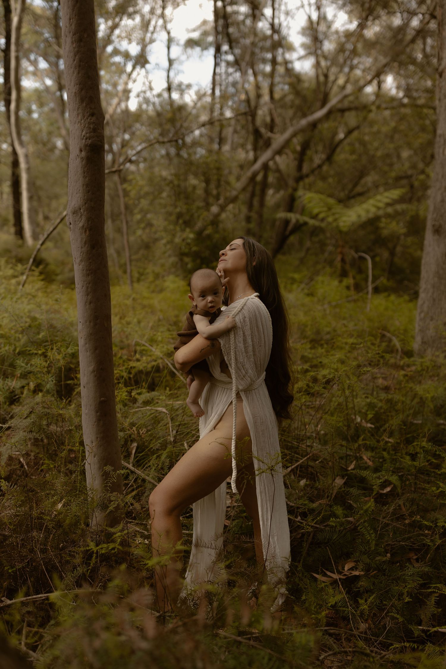 Artistic portrait series in a misty forest setting showing contemplative poses in flowing white fabric.