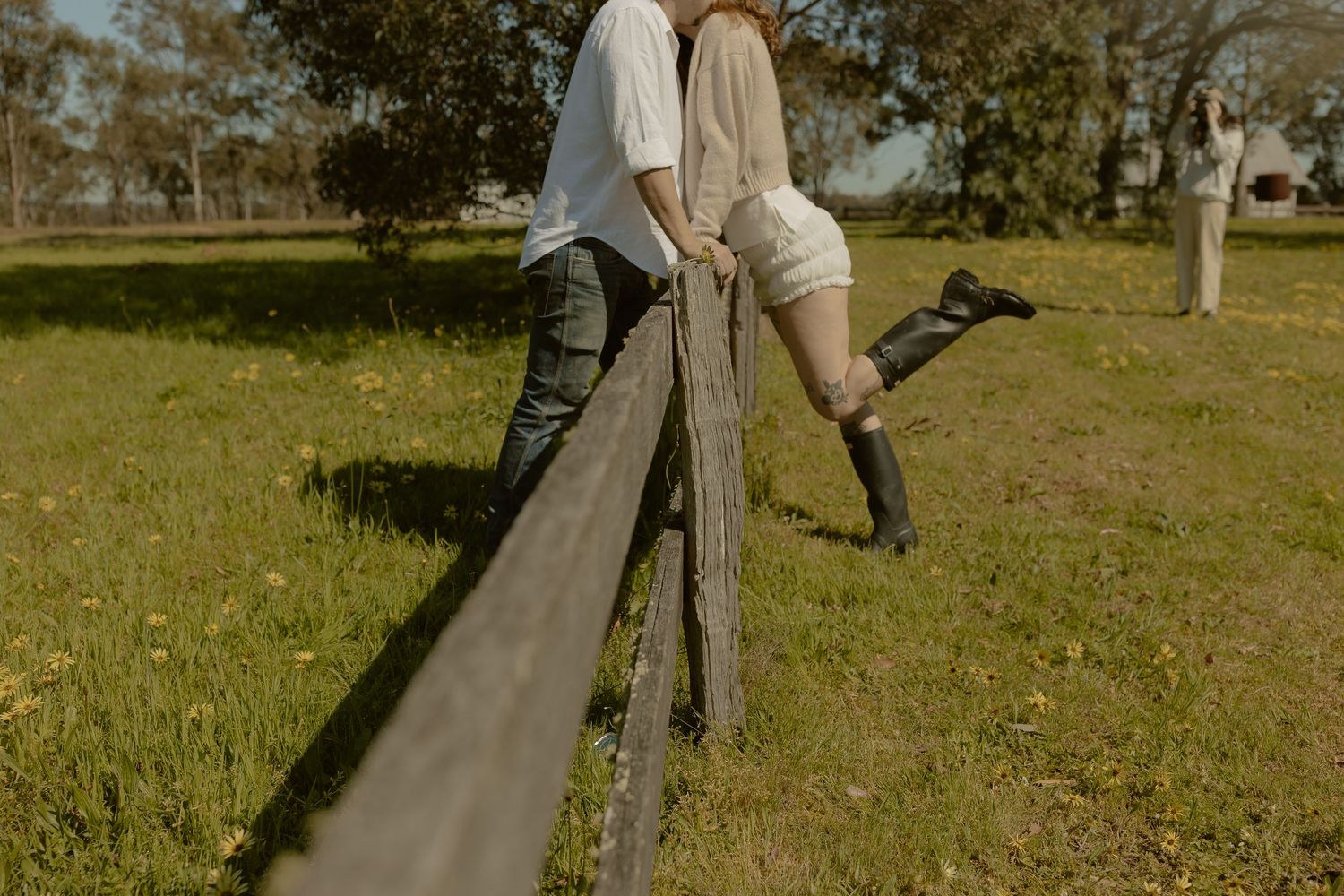 Two people enjoying a peaceful motorized skateboarding session along a paved pathway through a grassy park.