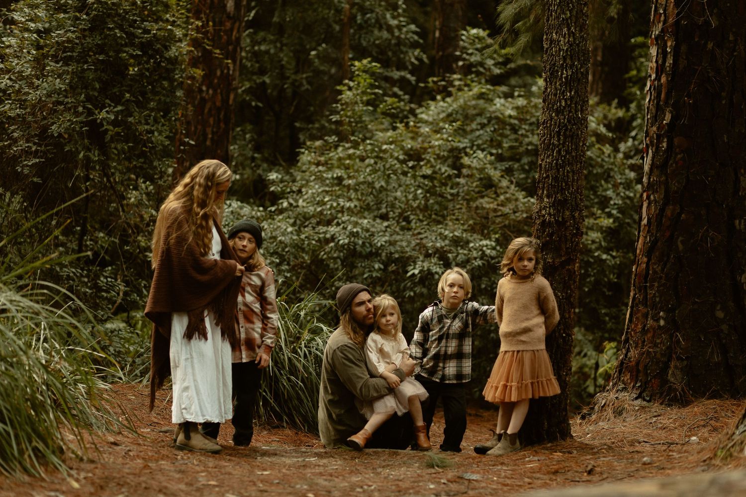 A group enjoying a peaceful moment together on a forest path surrounded by lush greenery.